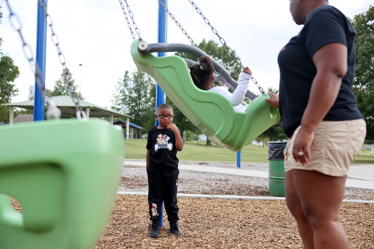  Carter pouts while his grandmother Oola pushes his cousin, Honesty, 3, on a swing. Carter has some behavioral issues that may be connected to his medical conditions, and he struggles with transitions throughout the day. “We don’t let nothing stress 