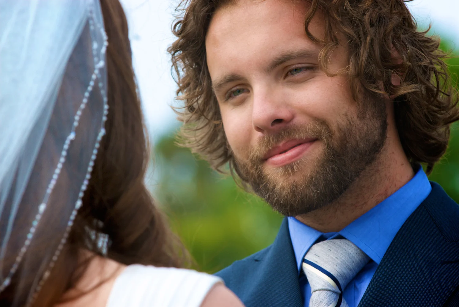 Groom smiling at his bride.