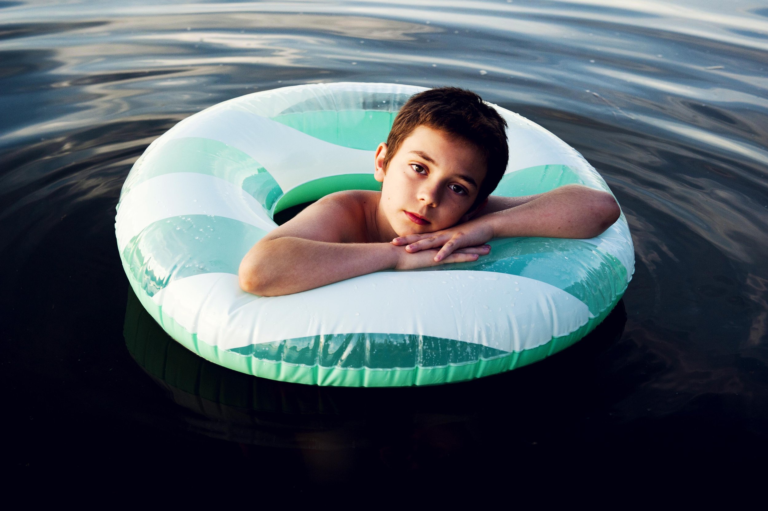 boy on raft in american river.jpg