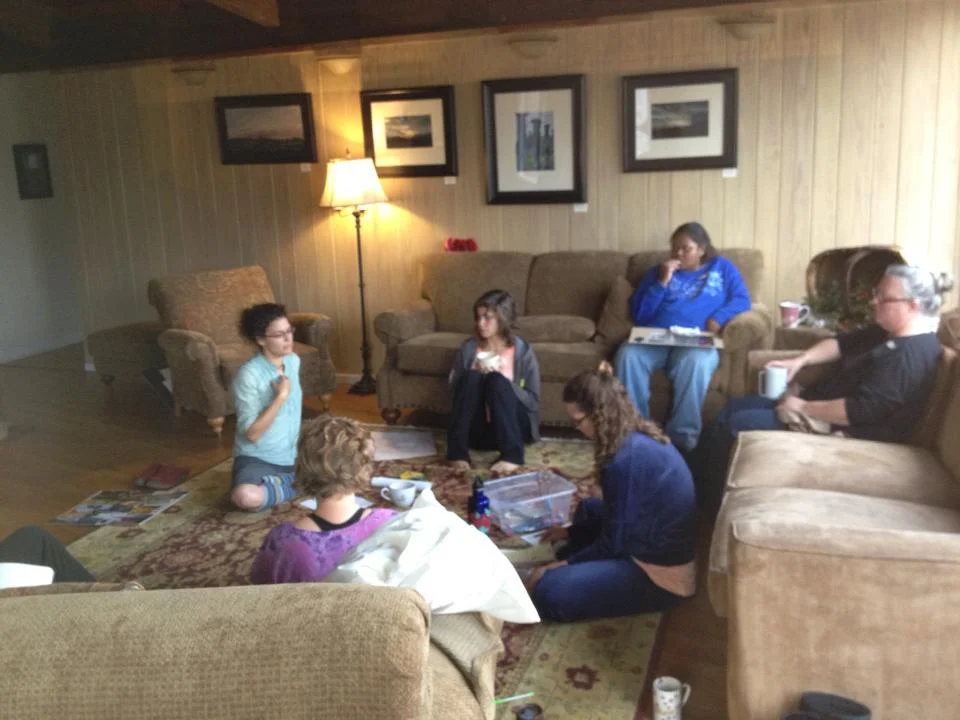Women learning, growing, sharing in a small break out group at a past retreat