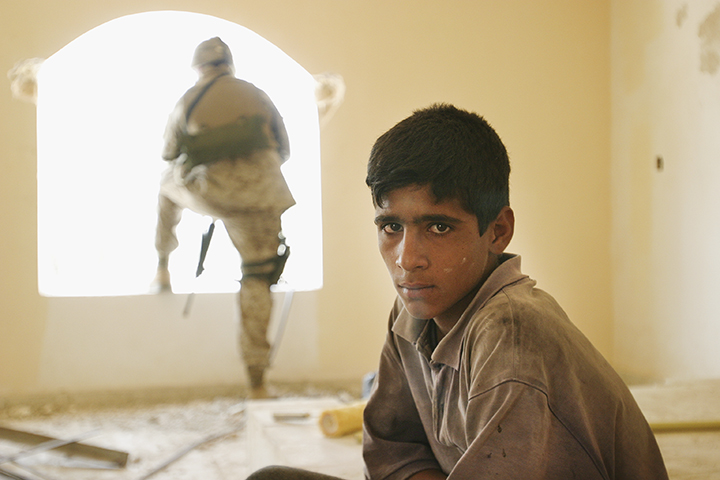 Boy on construction team for birth center funded then defunded by U.S. Army. Marines promised to resume support — if local leaders cooperated. Jurf-al-Sakhar, Iraq, August 8, 2004