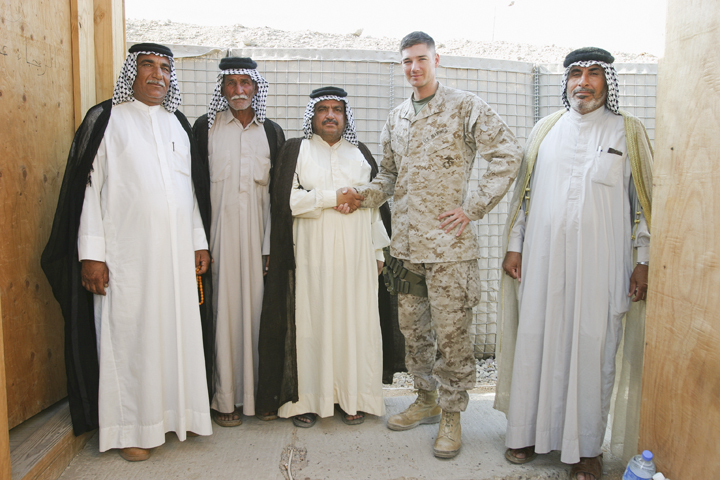 Marine major from Civil Affairs Group poses with sheikhs after reviewing their weapons permits, FOB Iskan, August 7, 2004