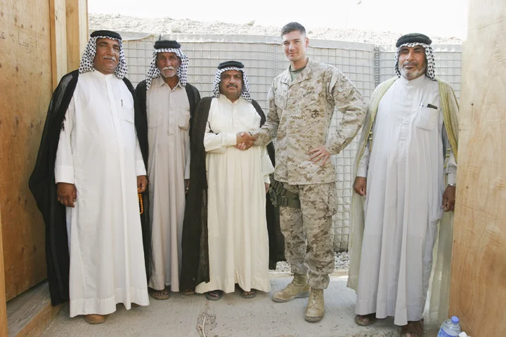 Marine major from Civil Affairs Group poses with sheikhs after reviewing their weapons permits, FOB Iskan, August 7, 2004