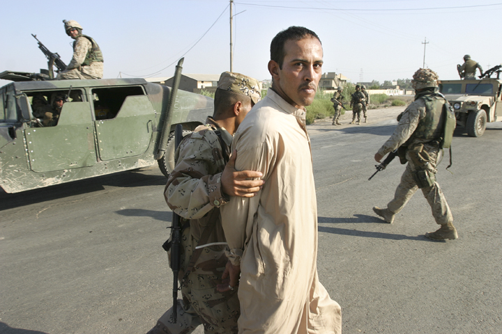 Iraqi man detained by Iraqi soldier after argument, Iskandariyah, Iraq, August 5, 2004