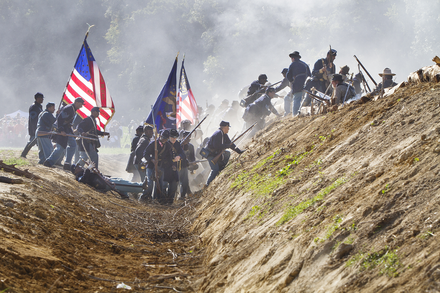  Union troops, including USCT, overrun a Confederate position during a reenactment of the battle of New Market Heights. Henrico, Co., Virginia, September 2014 