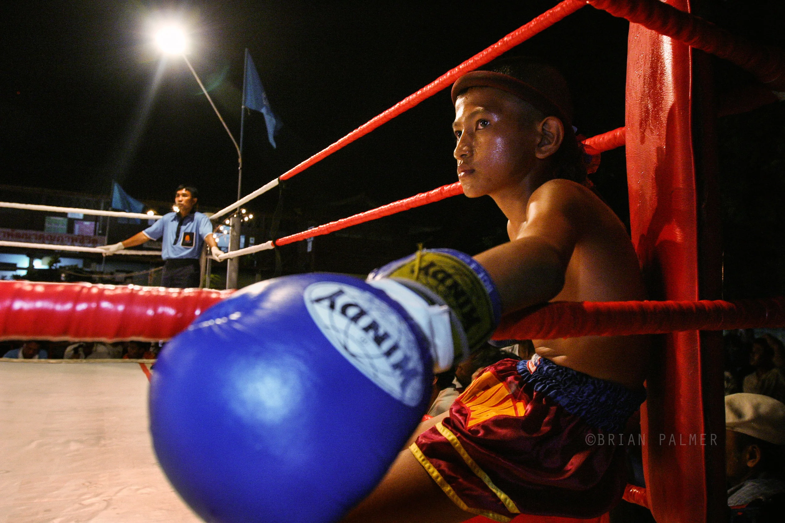 Young muayThai fighter before his bout during a series of fights marking Queen Sirikit's birthday, Bangkok Noi, Thailand, 2003