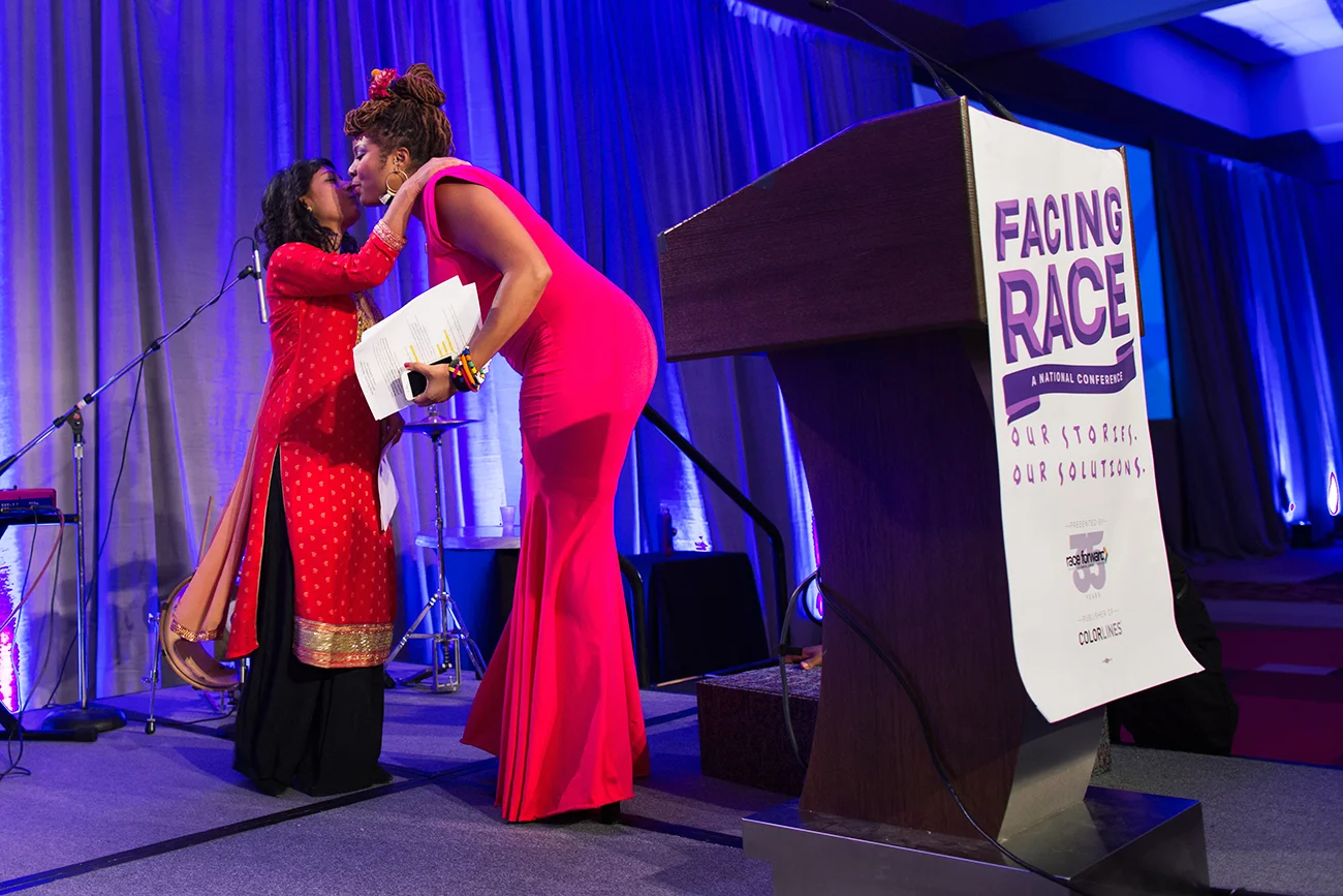 Rinku Sen, executive director of Race Forward, convenor of the Facing Race 2016 racial justice conference, greets emcee camil williams before leaving the stage to her, Atlanta, GA, 10 November