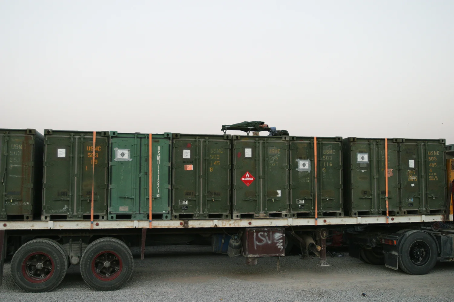 U.S. Army soldiers sleeps during break in a convoy north from Kuwait to Iraq, 2004