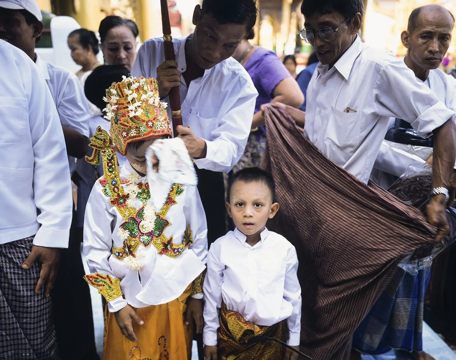  Ceremony for young man (having his face wiped) becoming a Buddhist novice, Shwedagon Paya, Rangoon, Burma (Yangon, Myanmar), 2003 