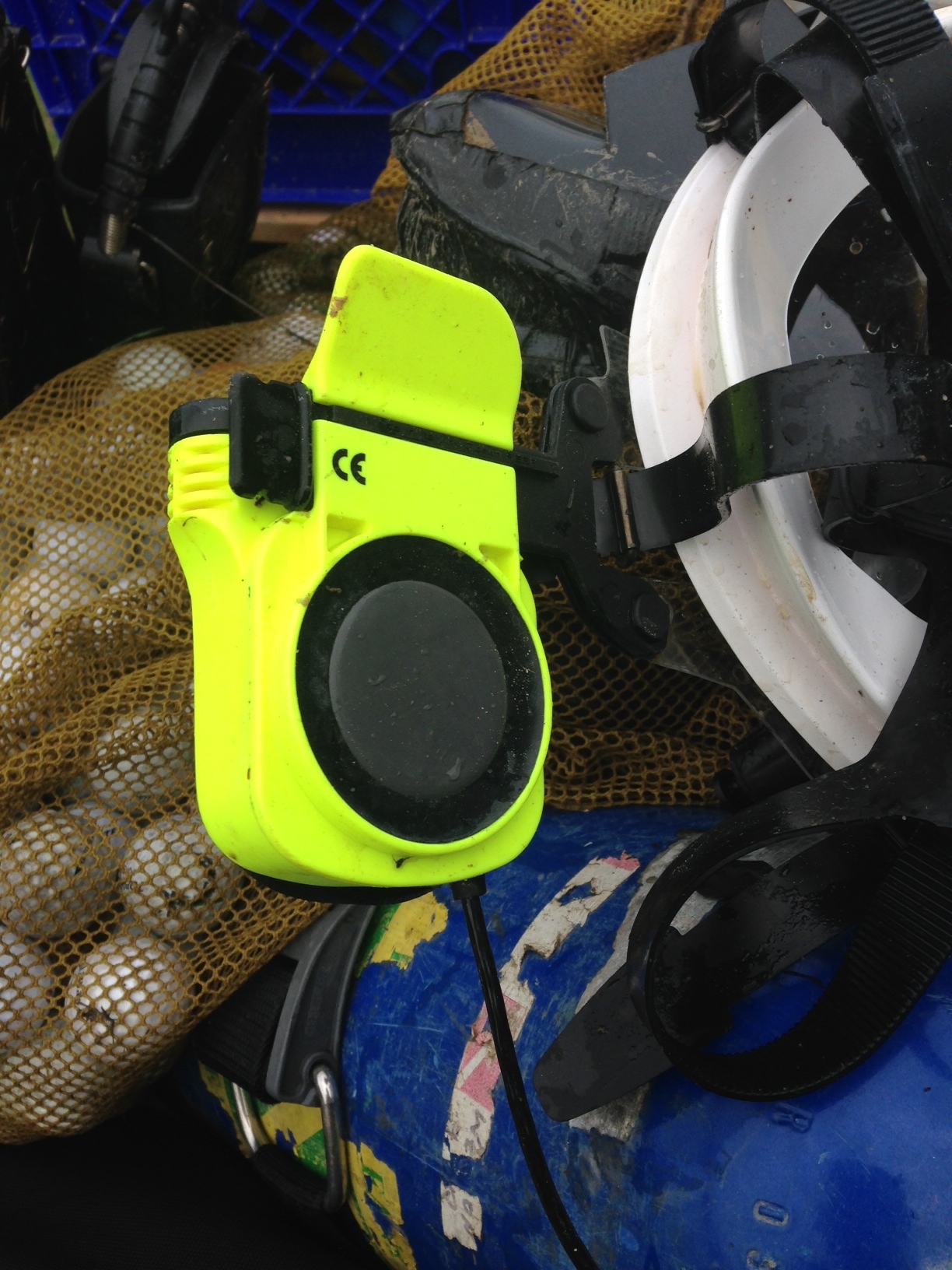 GSM mounted to side of the mask where it rests beside diver's ear