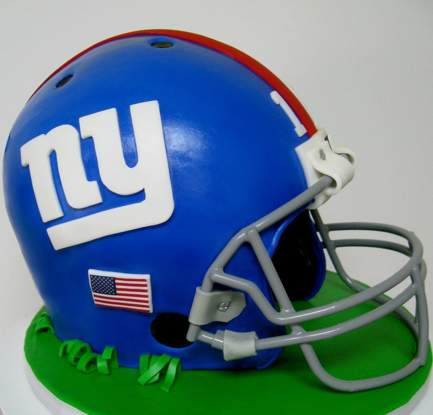 Chocolate groom's cake, face mask attached to this fan's cake with fondant strips