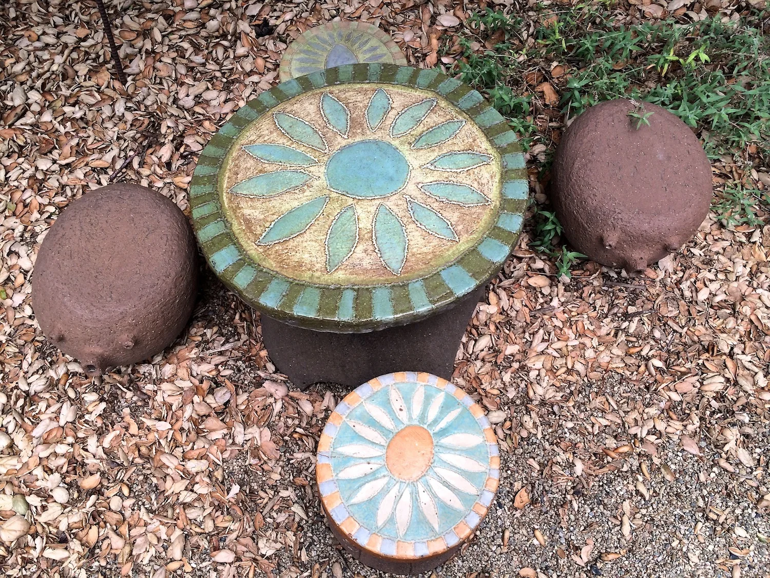 A vintage flower table and stools accompanied by Stan's whimsical animal stools.