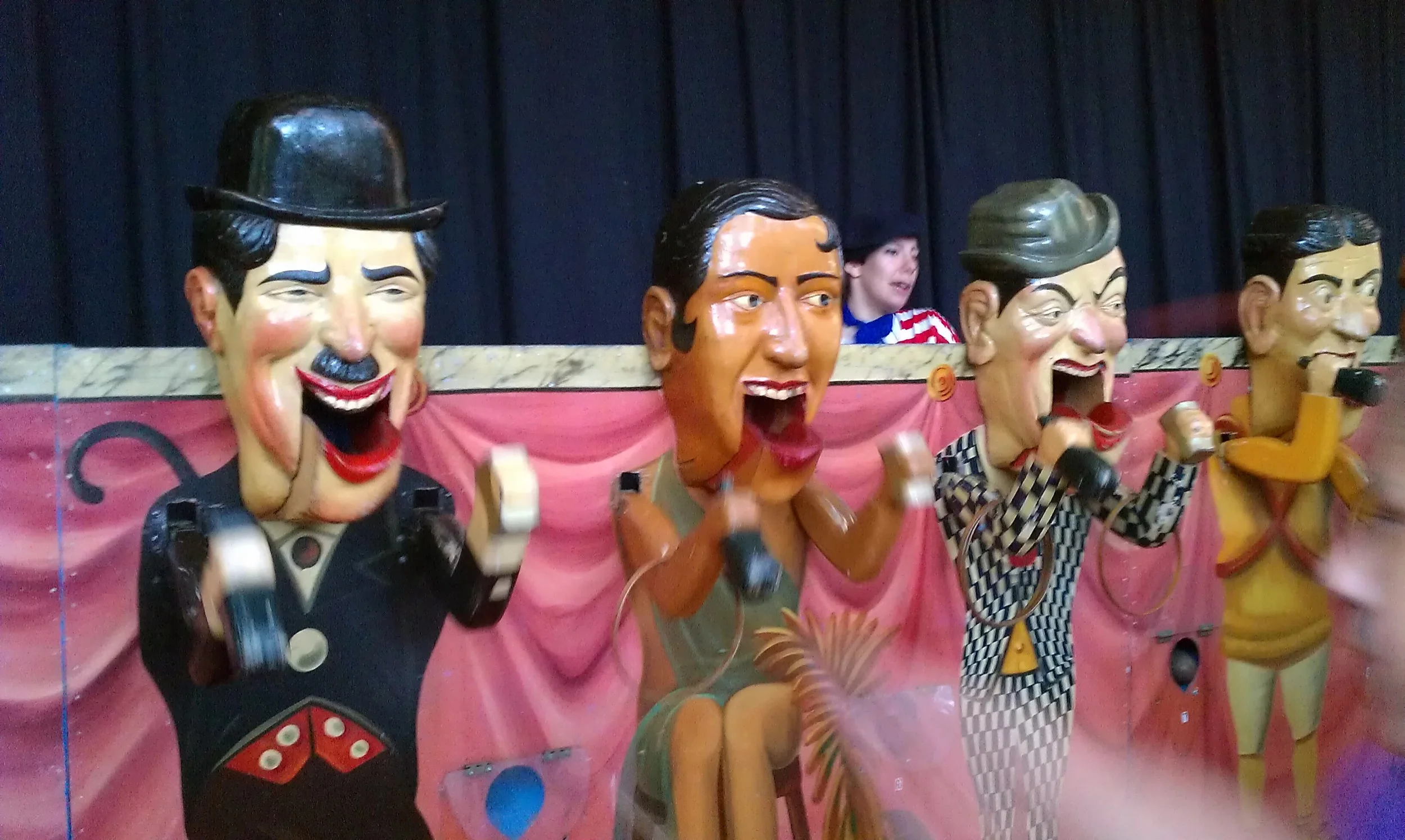 This game was operated by human powered wheels that when ridden on, like a bike, the mouths and arms of the puppet targets would move. Players had the choice of playing ring toss or ball toss.