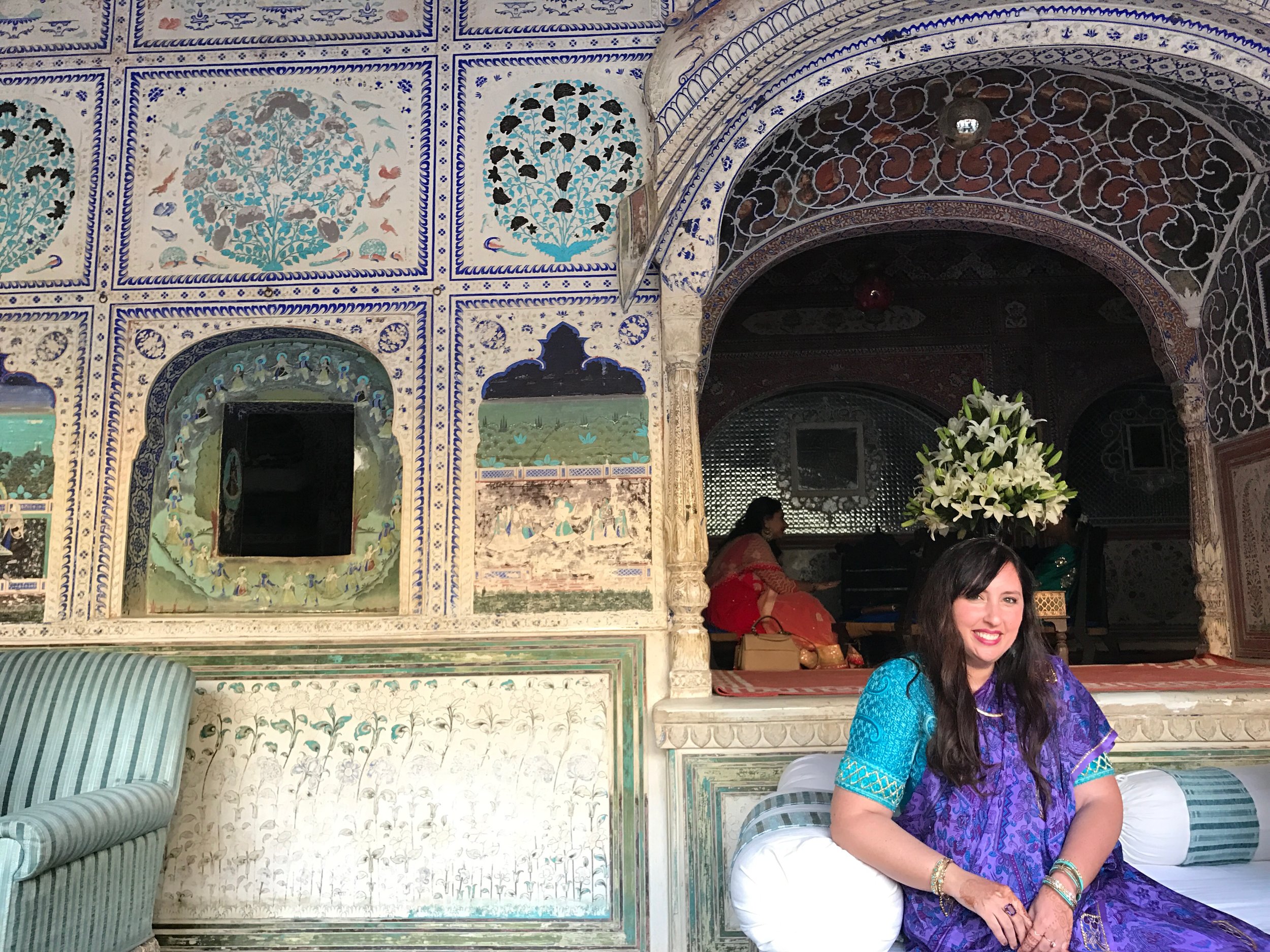 I got a vintage sari here in New York, but I needed help tying it and luckily, I had all the assistance I needed! I happened to coordinate with this gorgeous room at the palace, where we had chai, as one of the many wedding events.