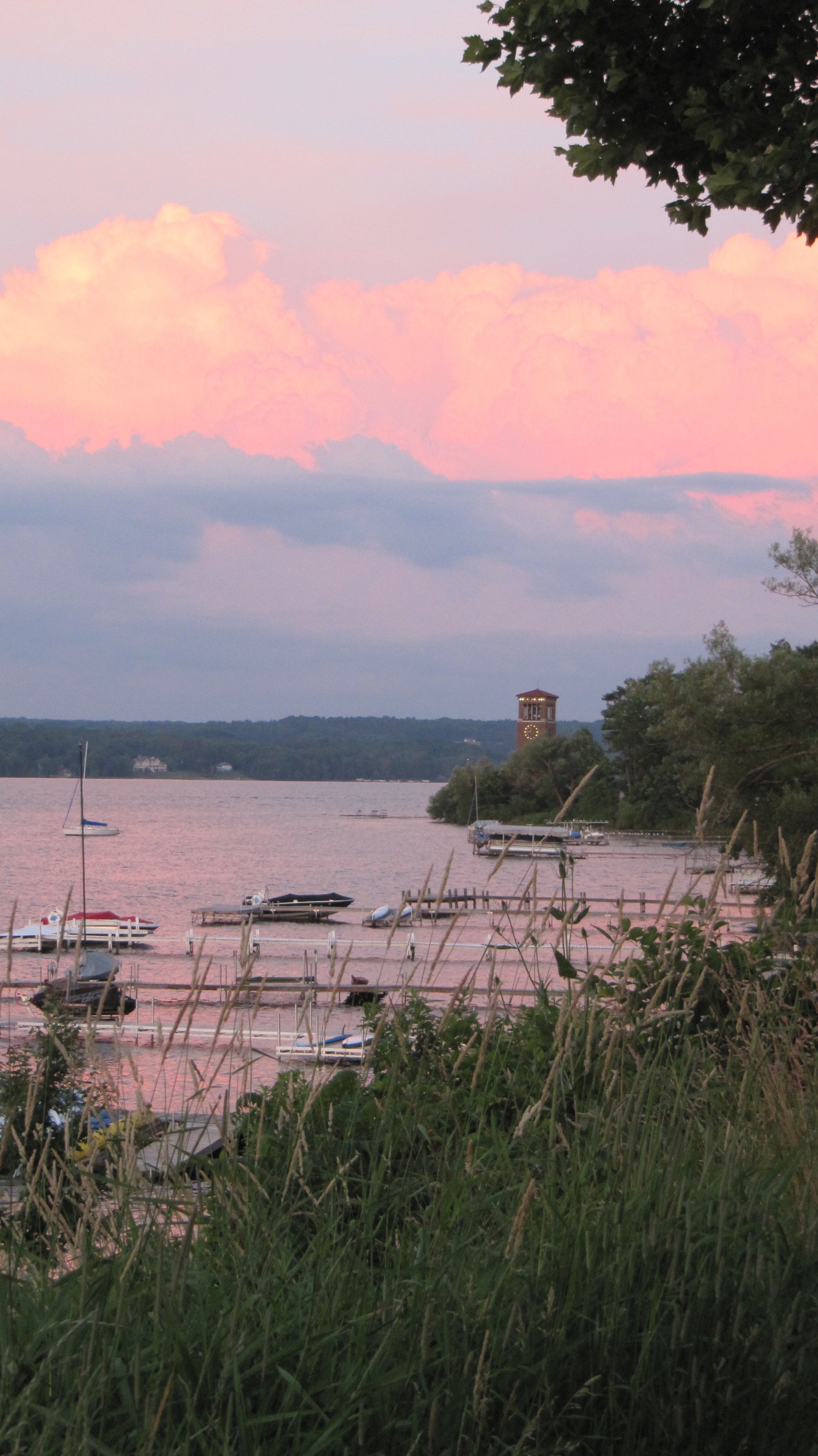 A passing summer storm backdrops the Chautauqua Institution Bell Tower at dusk.