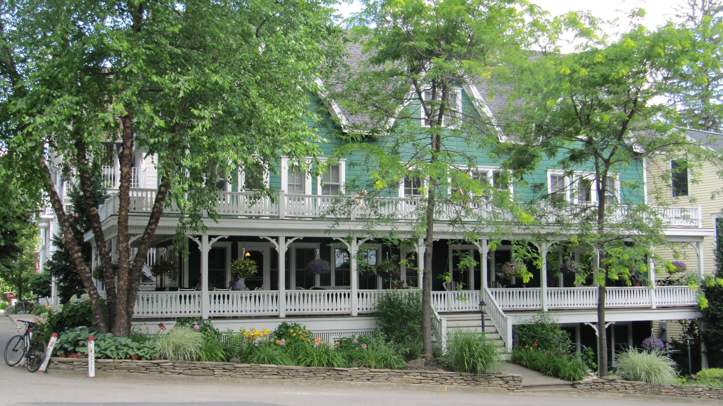 This splendid green and white new Victorian has porches that never end and is near the amphitheater. The architect did an amazing job with an awkwardly narrow and hilly spot.