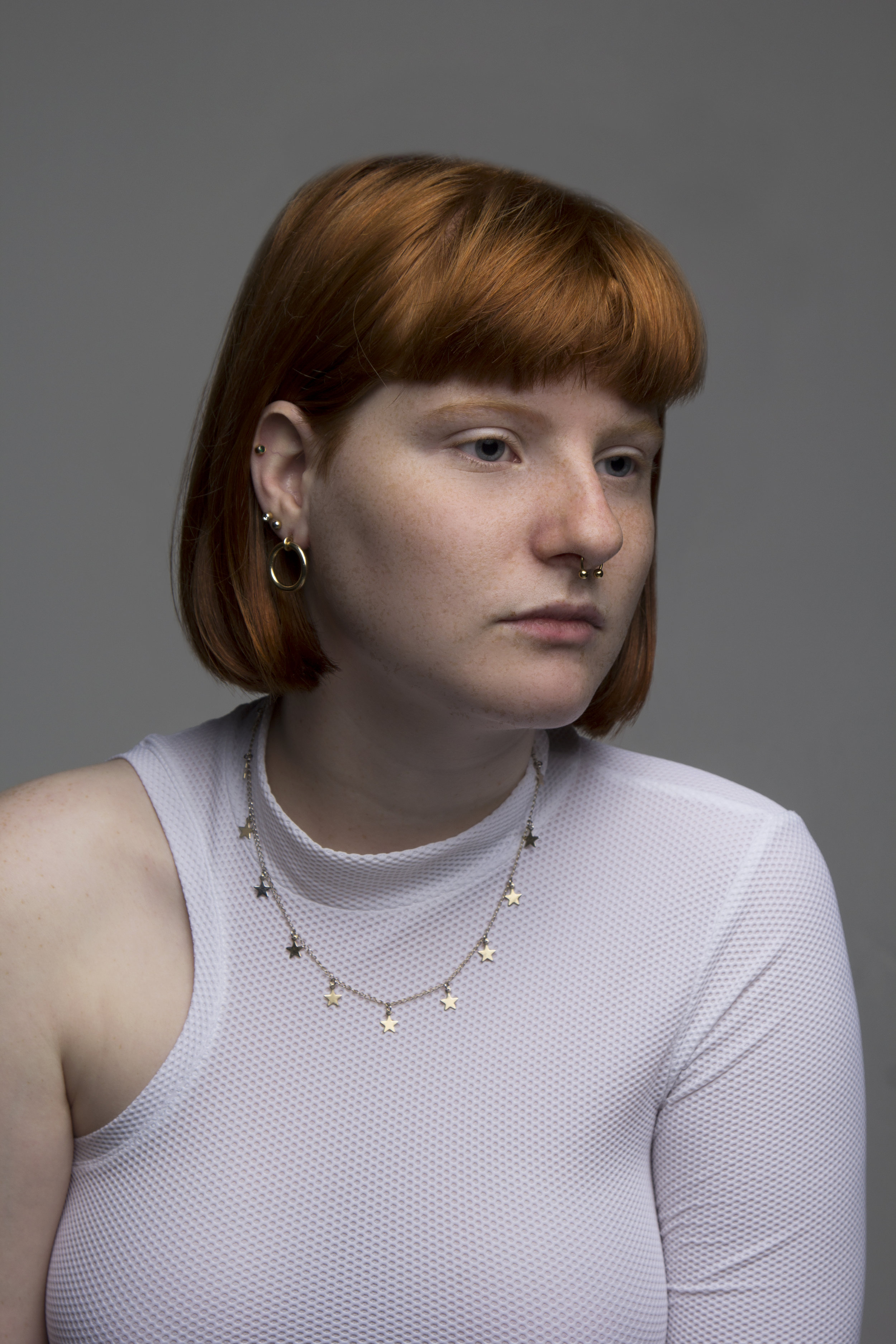 Halo stud earrings paired with Xanthe's own jewellery