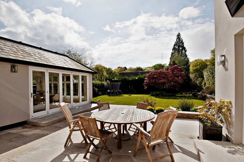 The property was then rebuilt following the architect's design and clients' vision. The rear garden to the property was also heavily landscaped to level the garden with hardwood retaining walls to create a usable space.