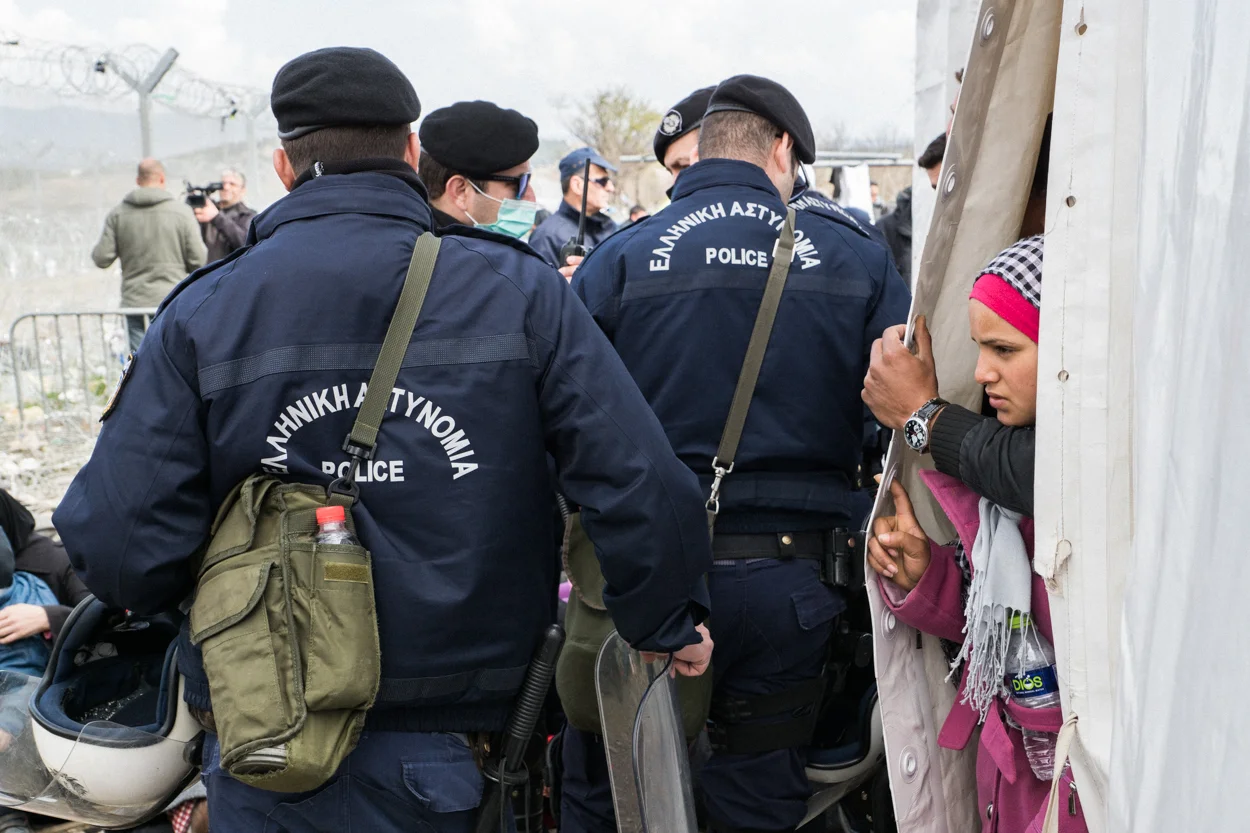 Idomeni, Greece – March 2, 2016 A refugee looks out from the International Organization of Migration tent in Idomeni, Greece, at the border crossing leading into Macedonia (FYROM).