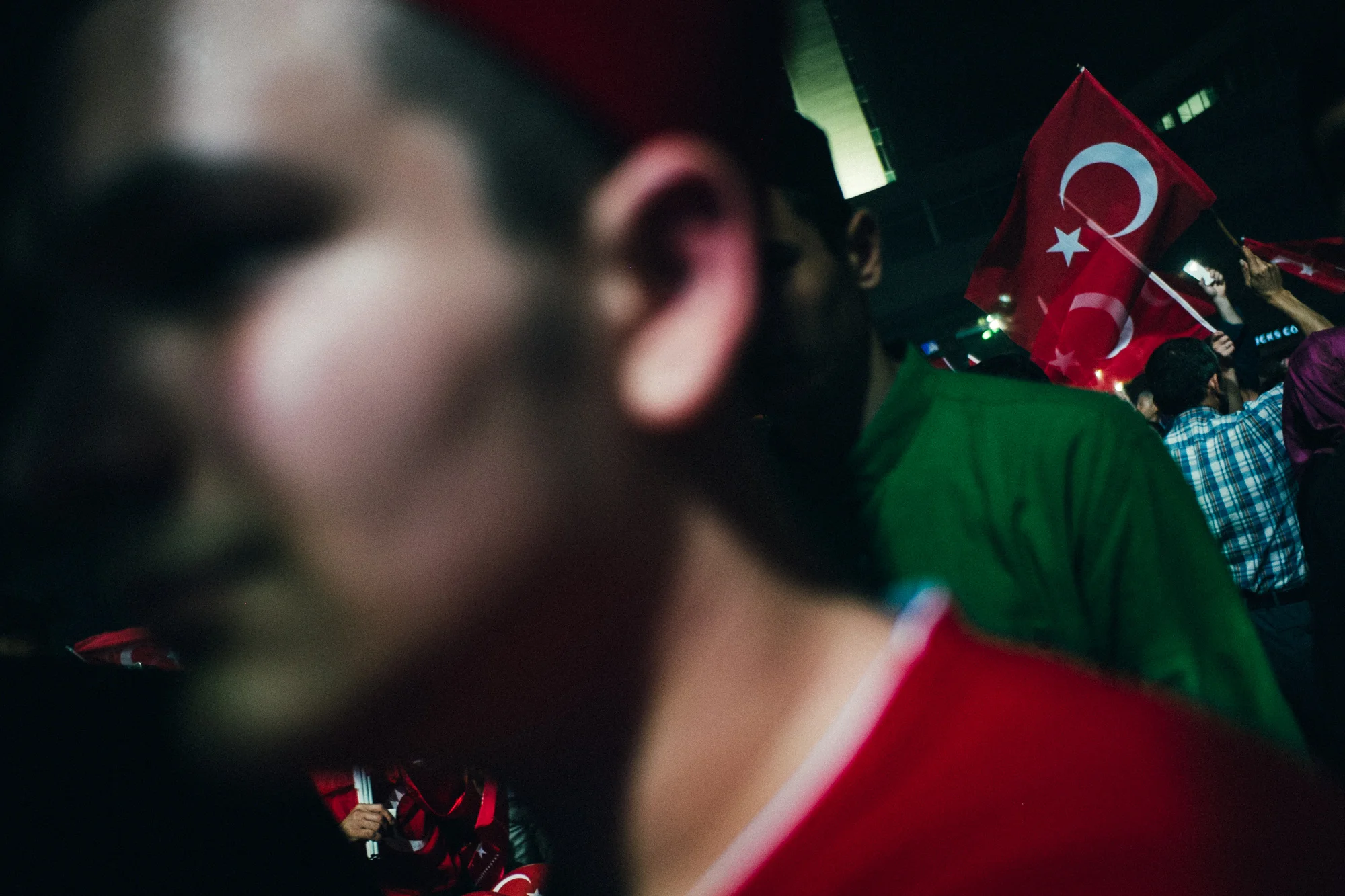 July 29, 2016 - Istanbul, Turkey. A man wearing a fez bearing the word "Türkiye" and a Turkish flag t-shirt participates in a pro-democracy rally in Taksim Square. 