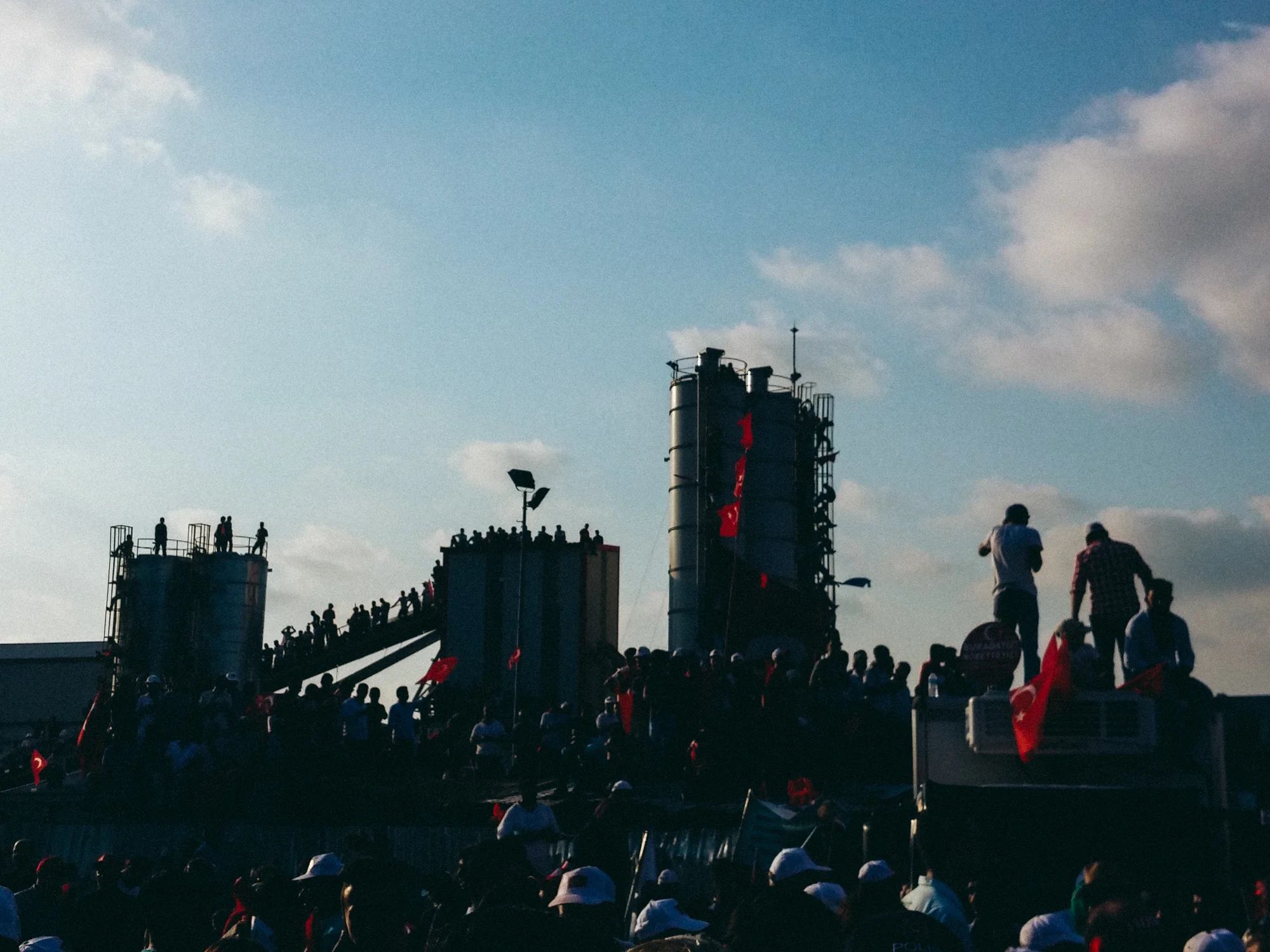 Aug. 7, 2016 - Istanbul, Turkey. Rally goers stand atop factory structures in order to get a view of the stage during the "Democracy and Martyrs Meeting." 