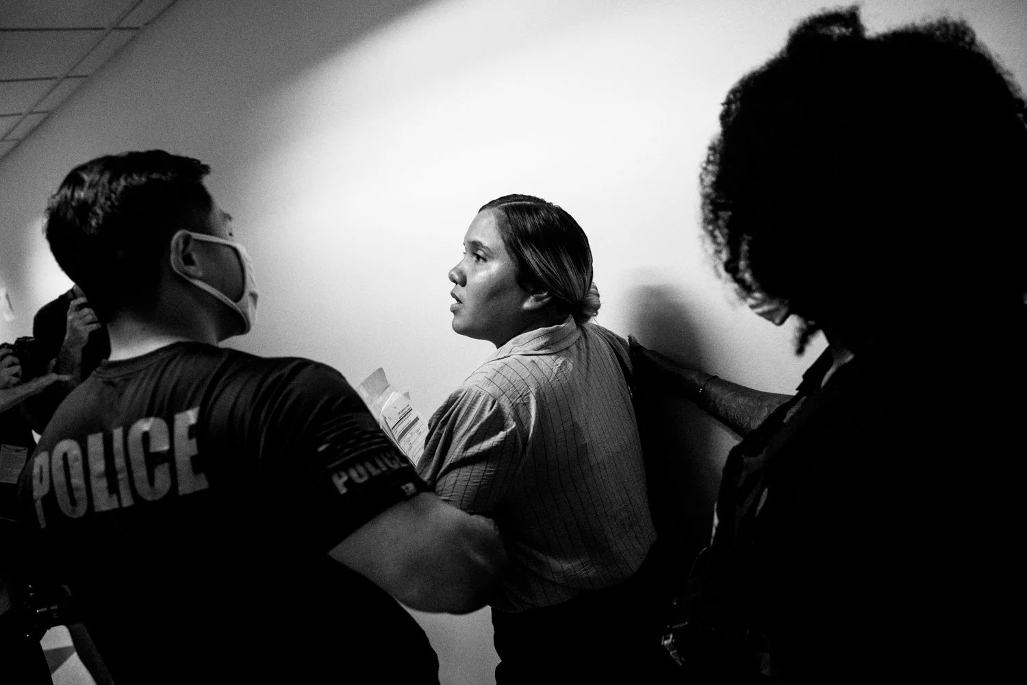  2:58 PM: Federal agents escort a detained woman following her immigration hearing in the Jacob K Javits Federal Building in New York on 16 July 2025.   Julius Constantine Motal/ The Guardian  