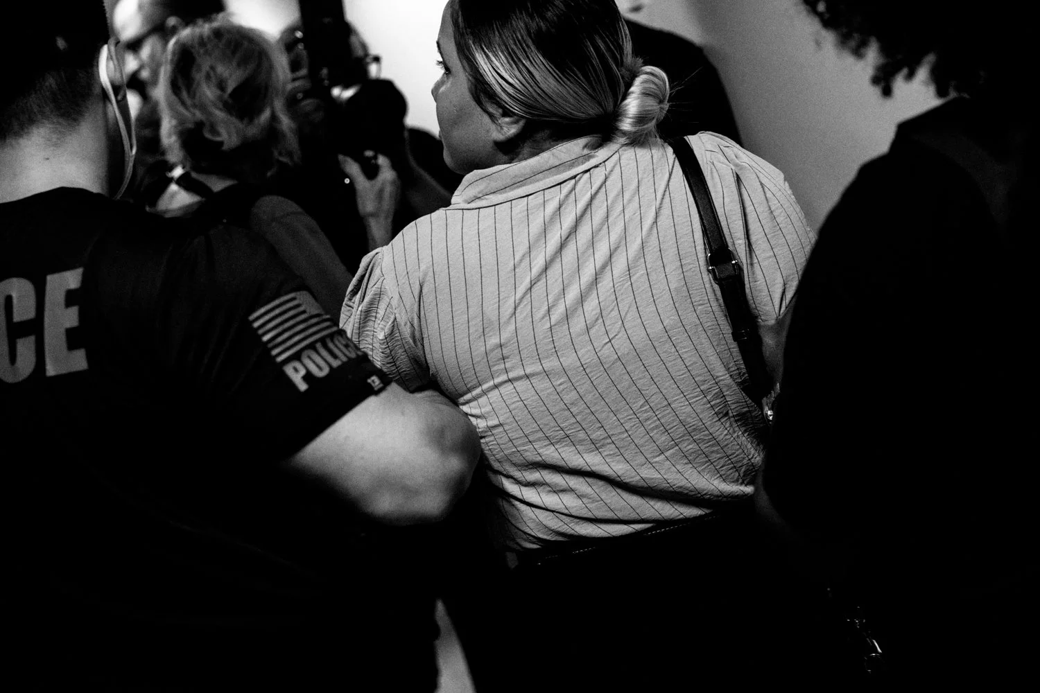  2:58 PM: Federal agents escort a detained woman following her immigration hearing in the Jacob K Javits Federal Building in New York on 16 July 2025.   Julius Constantine Motal/ The Guardian  