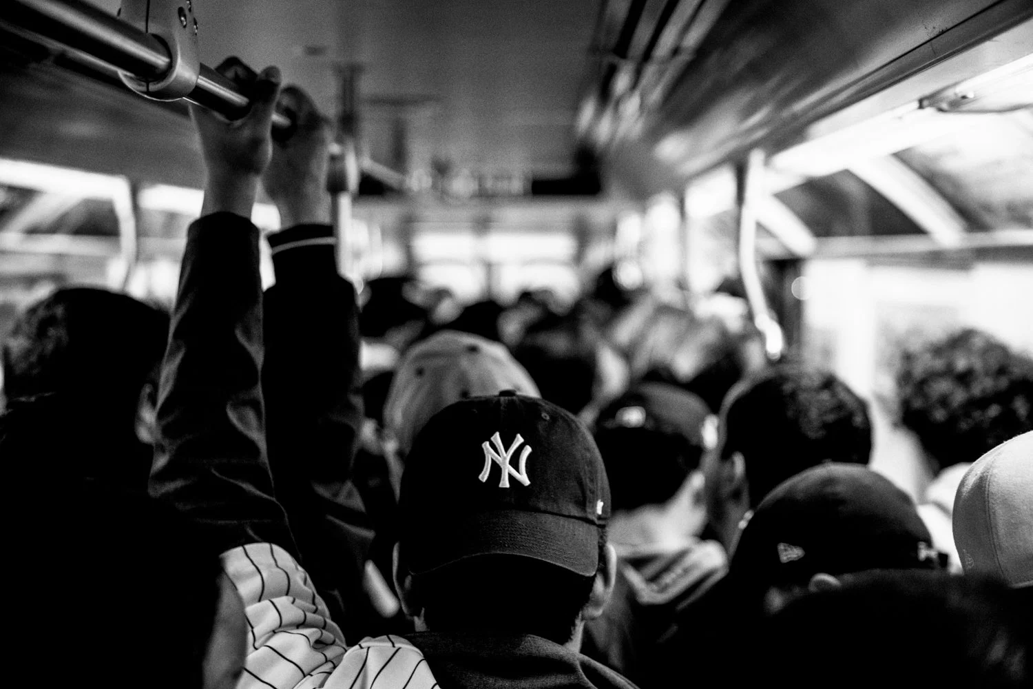  Yankees fans ride an uptown 4 train bound for Yankee Stadium in New York on 28 October 2024.  Julius Constantine Motal/ The Guardian  