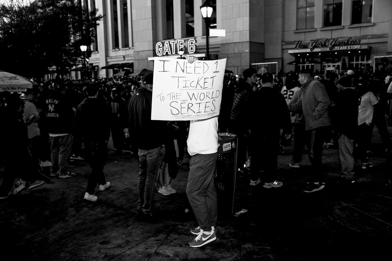  A man holds up a sign asking for a ticket to the World Series outside Yankee Stadium before game 3 in the Bronx, New York, on October 28, 2024.  Julius Constantine Motal/ The Guardian  