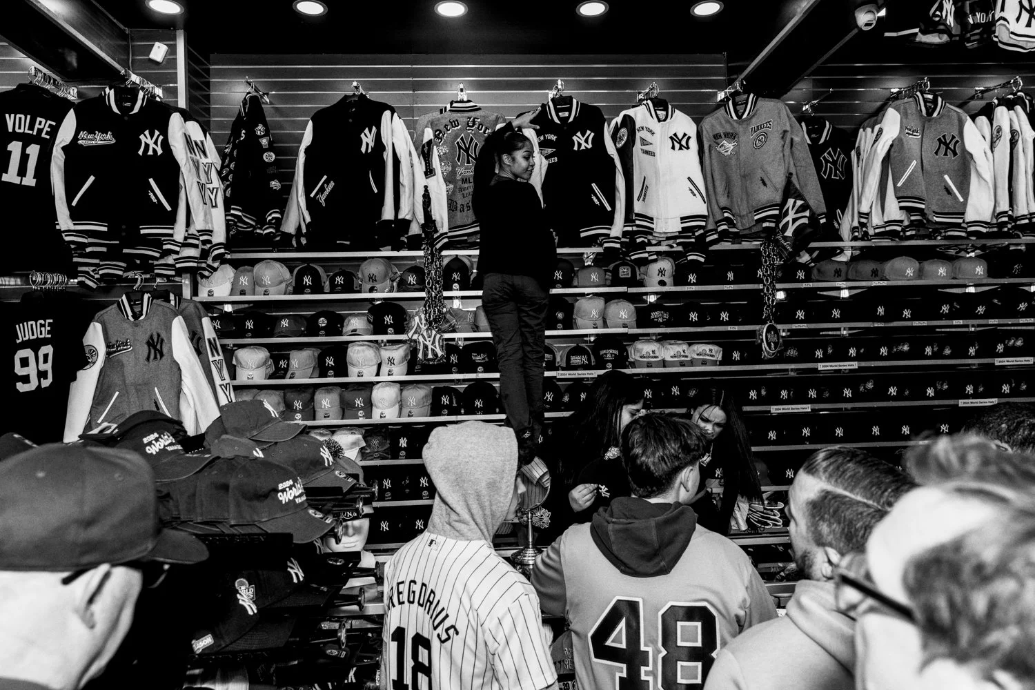  An employee helps a customer at Ballpark Sports Shop near Yankee Stadium ahead of Game 3 of the World Series in the Bronx, New York, on 28 October 2024.   Julius Constantine Motal/ The Guardian  