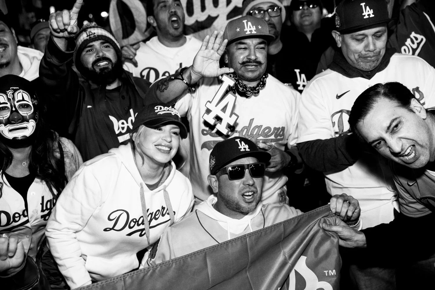  Dodgers fans pose for a photograph near Yankee Stadium ahead of Game 3 of the World Series in the Bronx, New York, on 28 October 2024.  Julius Constantine Motal/ The Guardian  