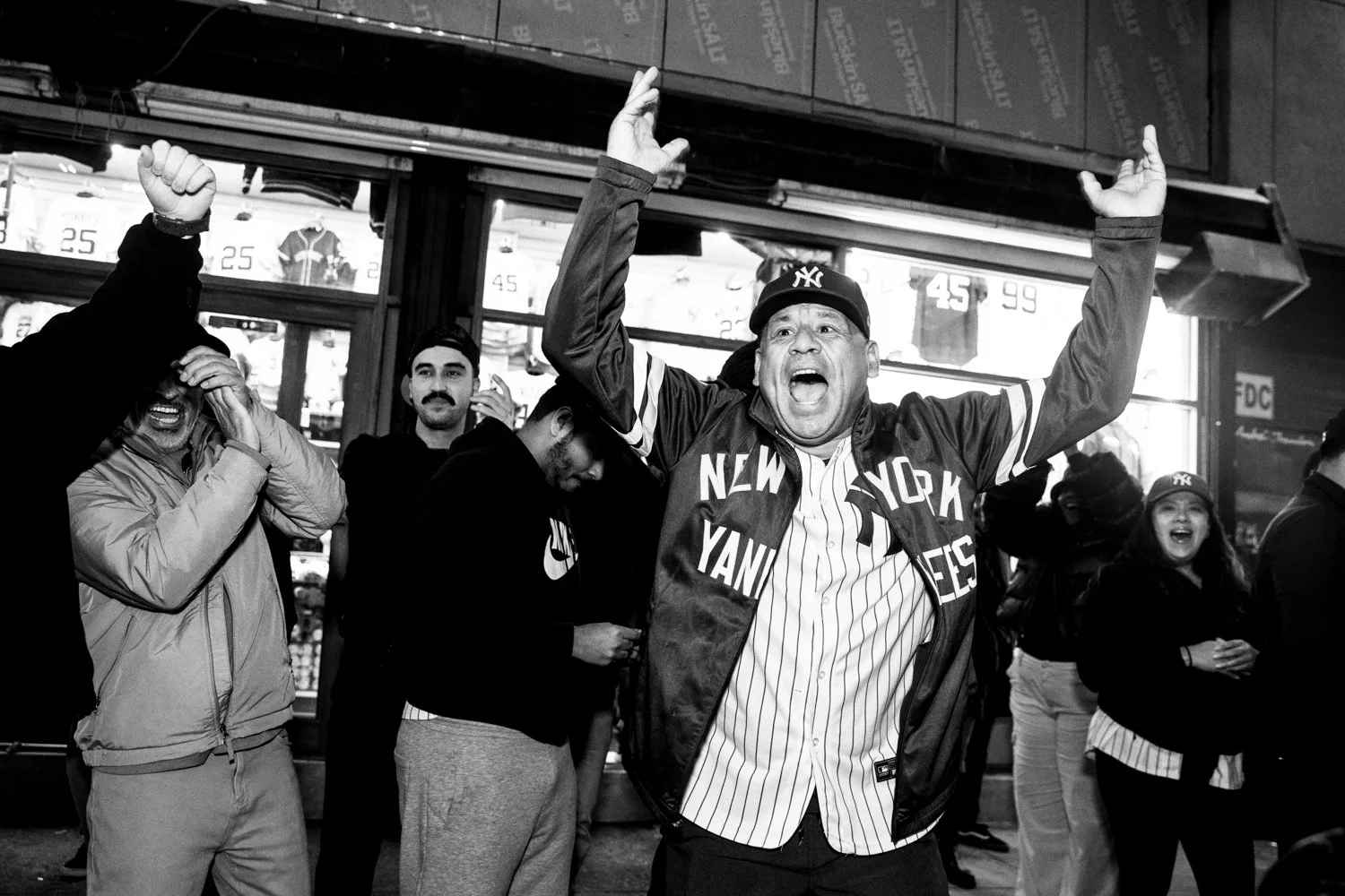  A Yankees fan riles up his fellow fans while waiting in line for Billy's Sports Bar near Yankee Stadium ahead of Game 3 of the World Series in the Bronx, New York, on October 28, 2024.   Julius Constantine Motal/ The Guardian  