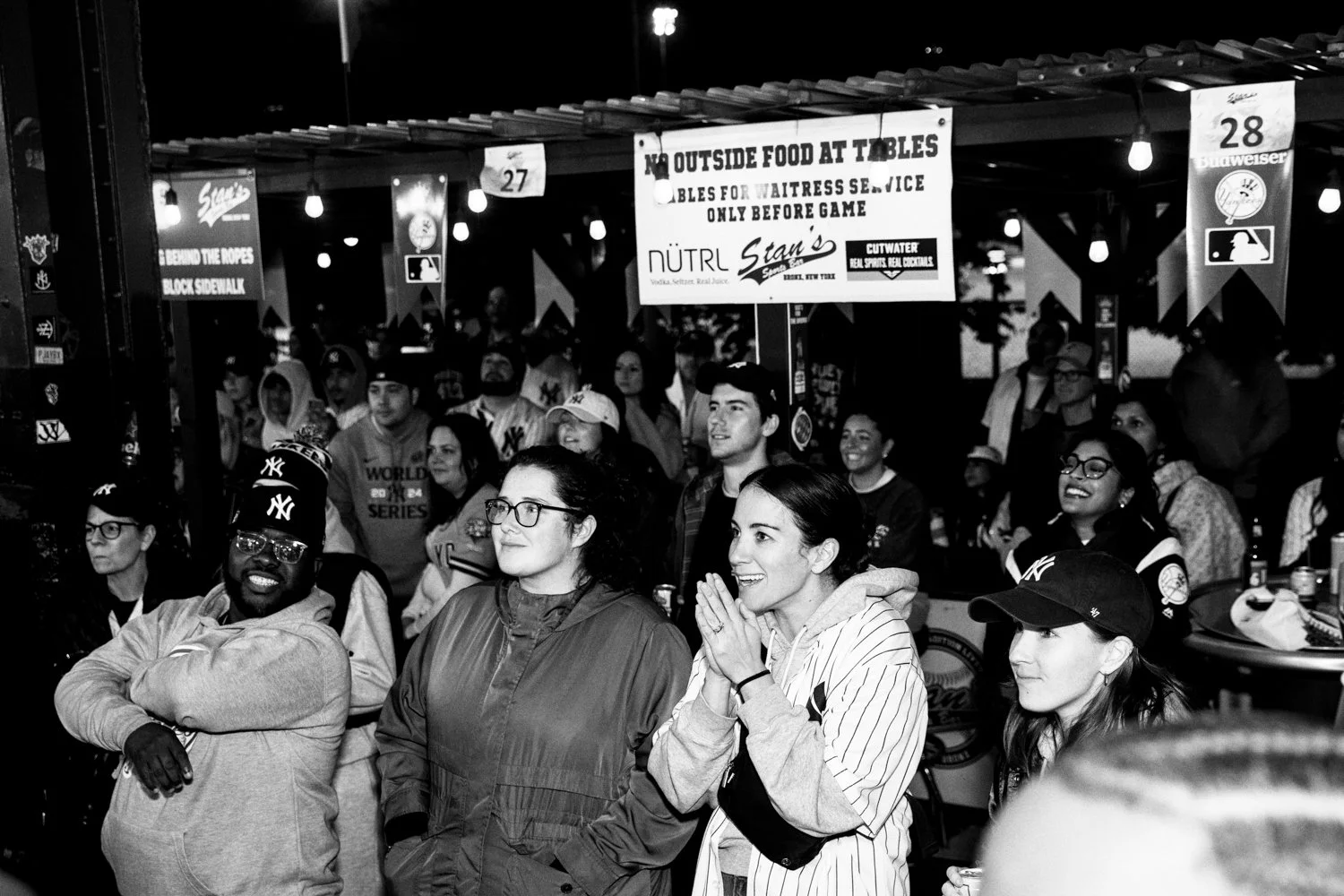  Yankees fans watch Yankees centerfielder Aaron Judge's first at bat in Game 3 of the World Series at Stan's Sports Bar near Yankee Stadium in the Bronx, New York, on October 28, 2024.  Julius Constantine Motal/ The Guardian  