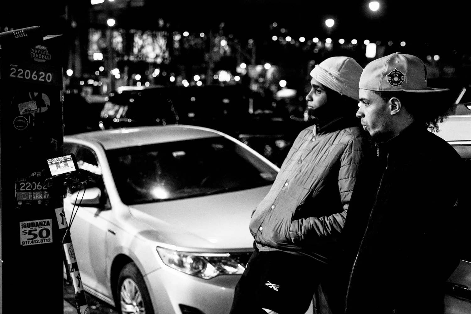  Two men watch a livestream of Game 3 of the World Series between the Yankees and the Dodgers on a smartphone up the street from Yankee Stadium in the Bronx, New York, on October 28, 2024.  Julius Constantine Motal/ The Guardian  