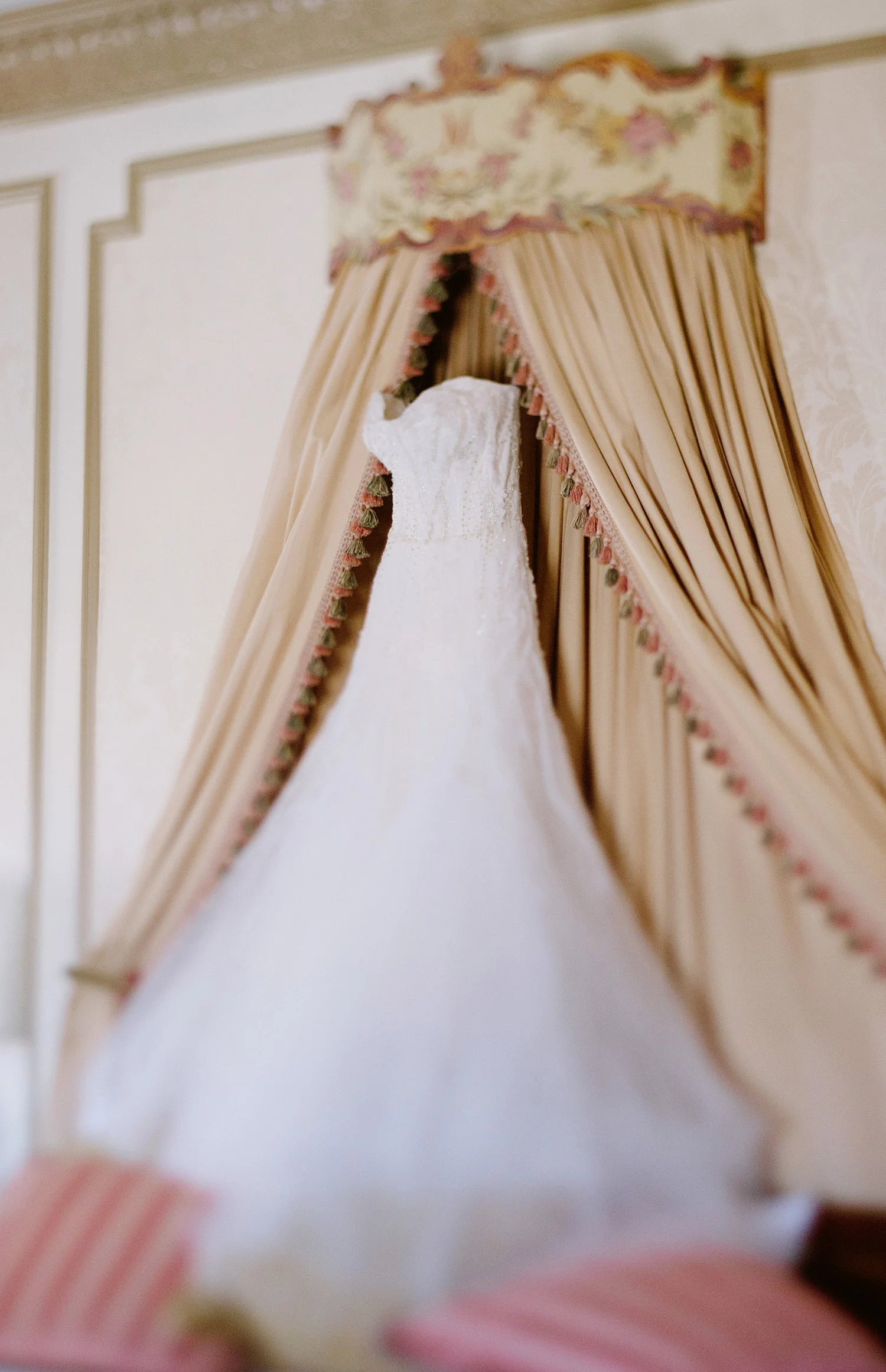 Pro football star Bryan Bulaga with the Green Bay Packers wedding at the Hilton City Center Milwaukee. Destination wedding photographer Lexia Frank photographs the dress hanging in the bridal suite at the Hilton City Center Milwaukee