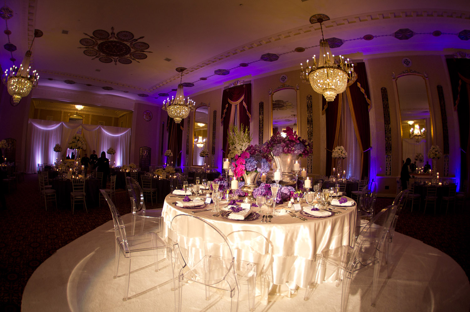 TOP DESTINATION WEDDING PHOTOGRAPHER LEXIA FRANK PHOTOGRAPHS PRO FOOTBALL PLAYER GREEN BAY PACKER BRYAN BULAGAS WEDDING AT THE HILTON CITY CENTER IN DOWNTOWN MILWAUKEE. LUCITE CLEAR CHAIRS WITH PURPLE FLORAL 