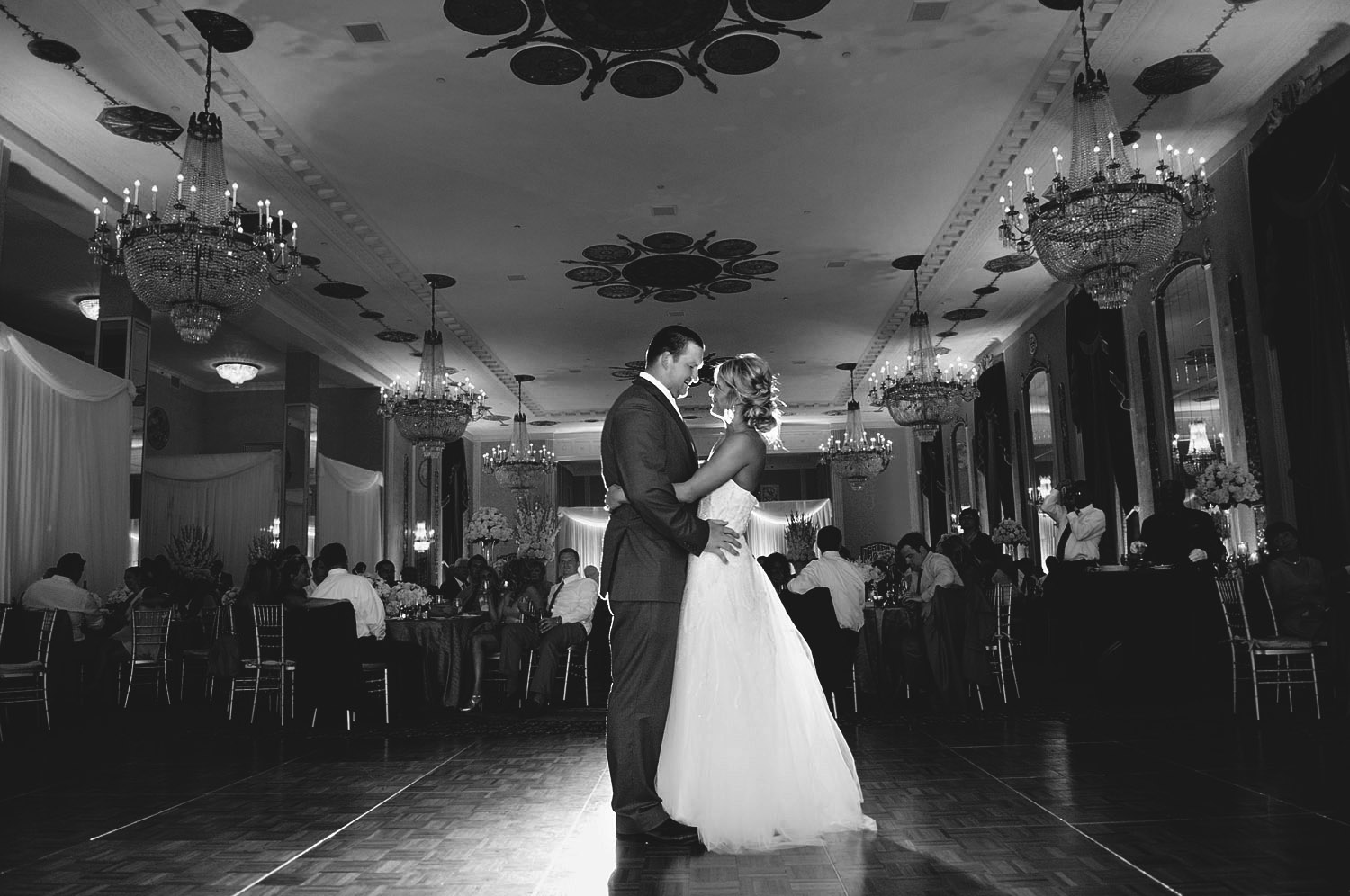 PRO FOOTBALL PLAYER BRYAN BULAGA SHARES A FIRST DANCE WITH HIS WIFE WHILE LEXIA FRANK, TOP DESTINATION WEDDING PHOTOGRAPHER PHOTOGRAPHS IN FILM AT THE HILTON CITY CENTER IN DOWNTOWN MILWAUKEE WEDDING