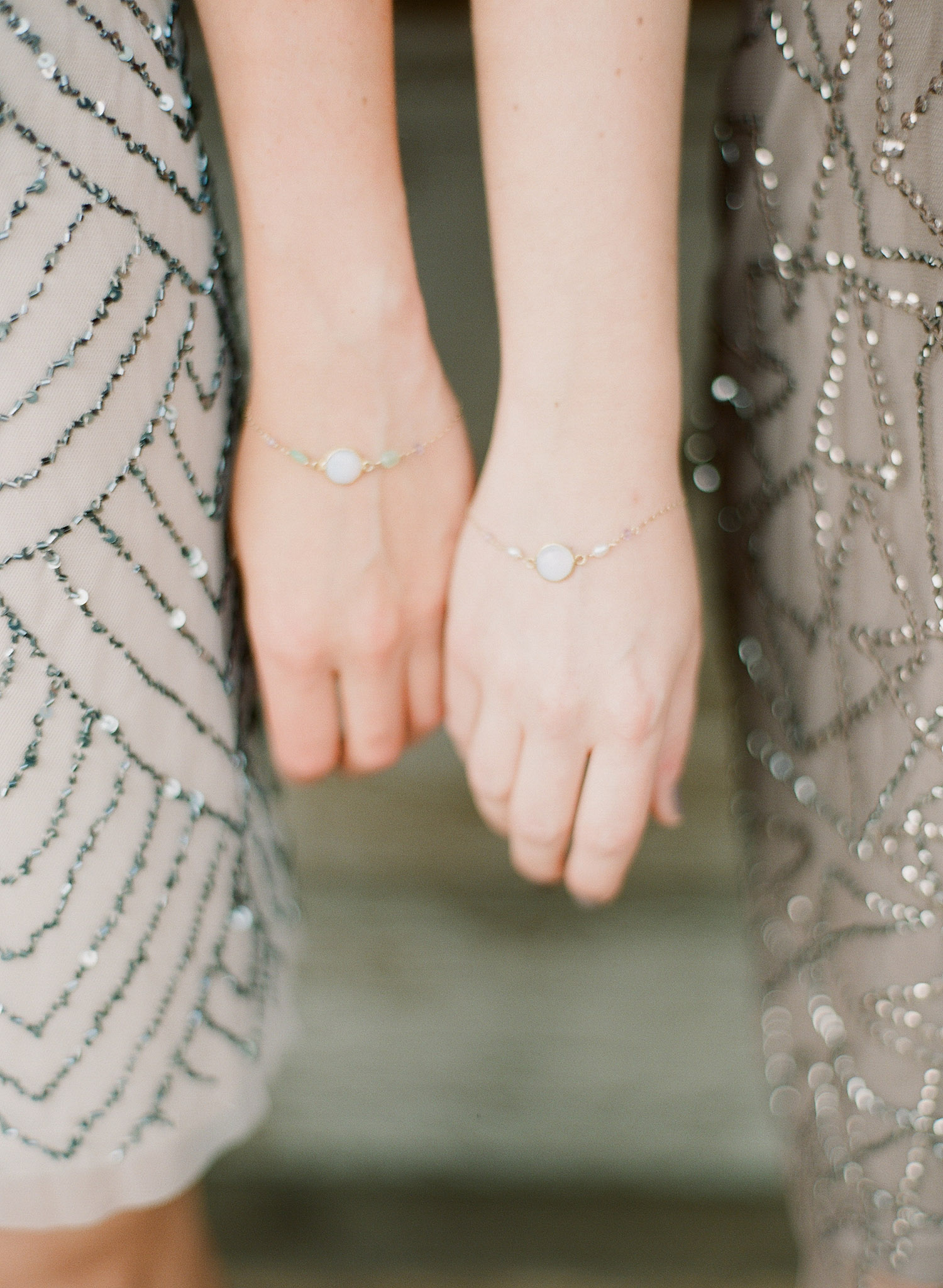bride gave her bridesmaids gifts of bracelets for her springtime wedding at Northwind Perennial Gardens in wisconsin while Destination wedding photographer lexia frank photographs her wedding in film 