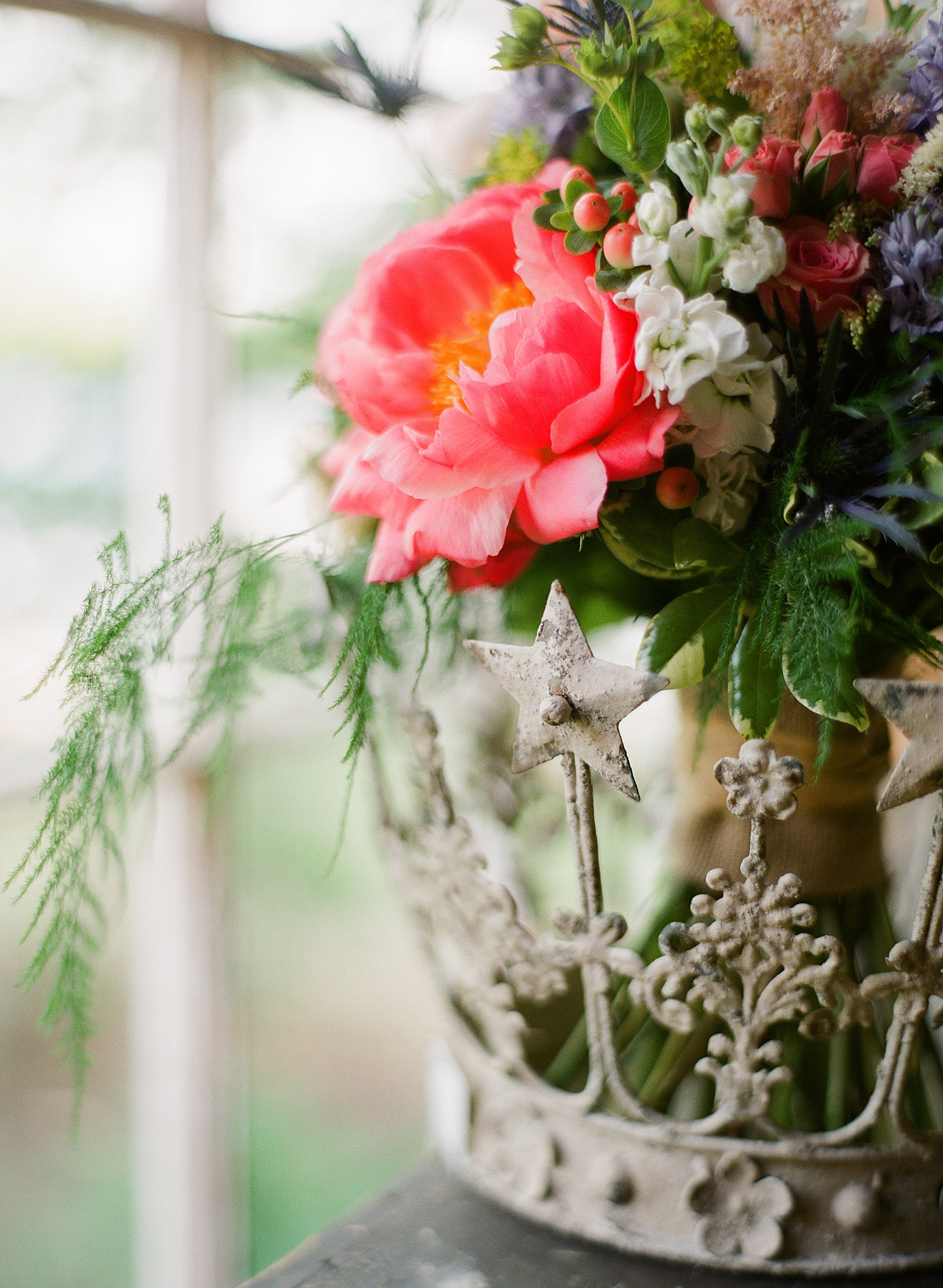 detail image of the peony and ferm asymmetrical bouquet at this springtime wedding at Northwind Perennial gardens - a wisconsin wedding venue - as a film wedding photographer Lexia Frank photographs this destination wedding on film
