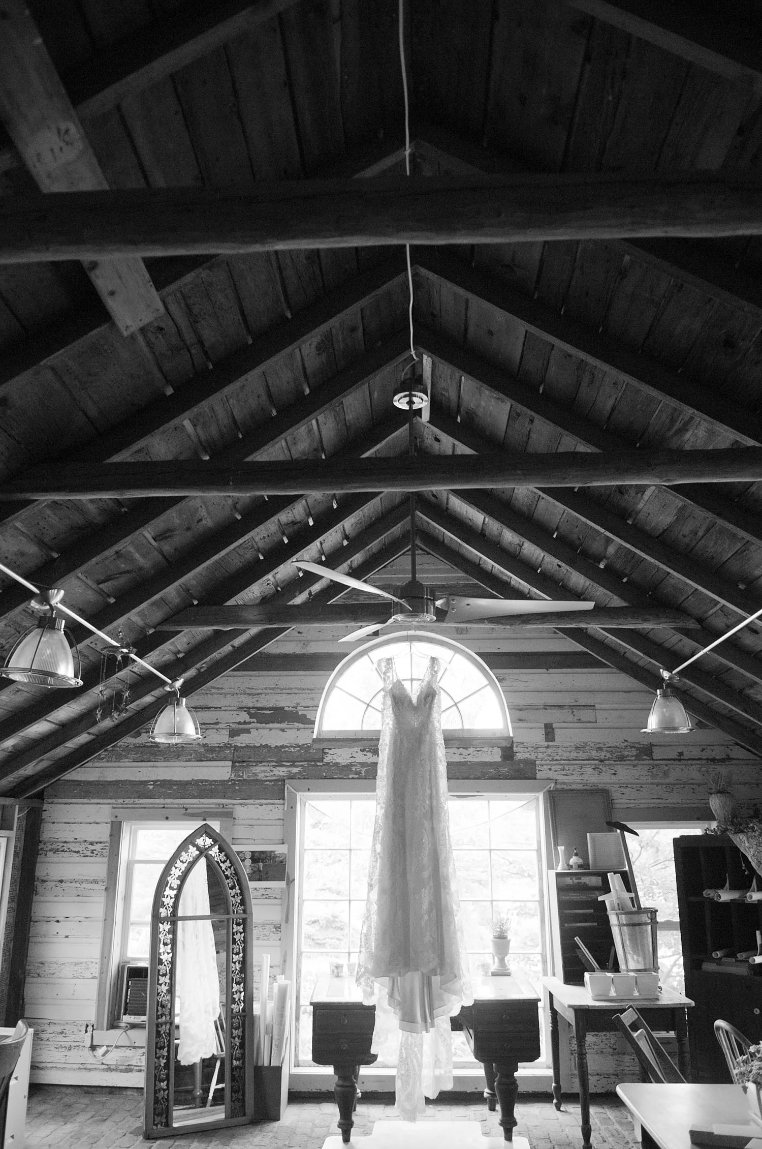dress hangs from the rafters at this springtime wedding at Northwind Perennial gardens - a wisconsin wedding venue - as a film wedding photographer Lexia Frank photographs this destination wedding on film
