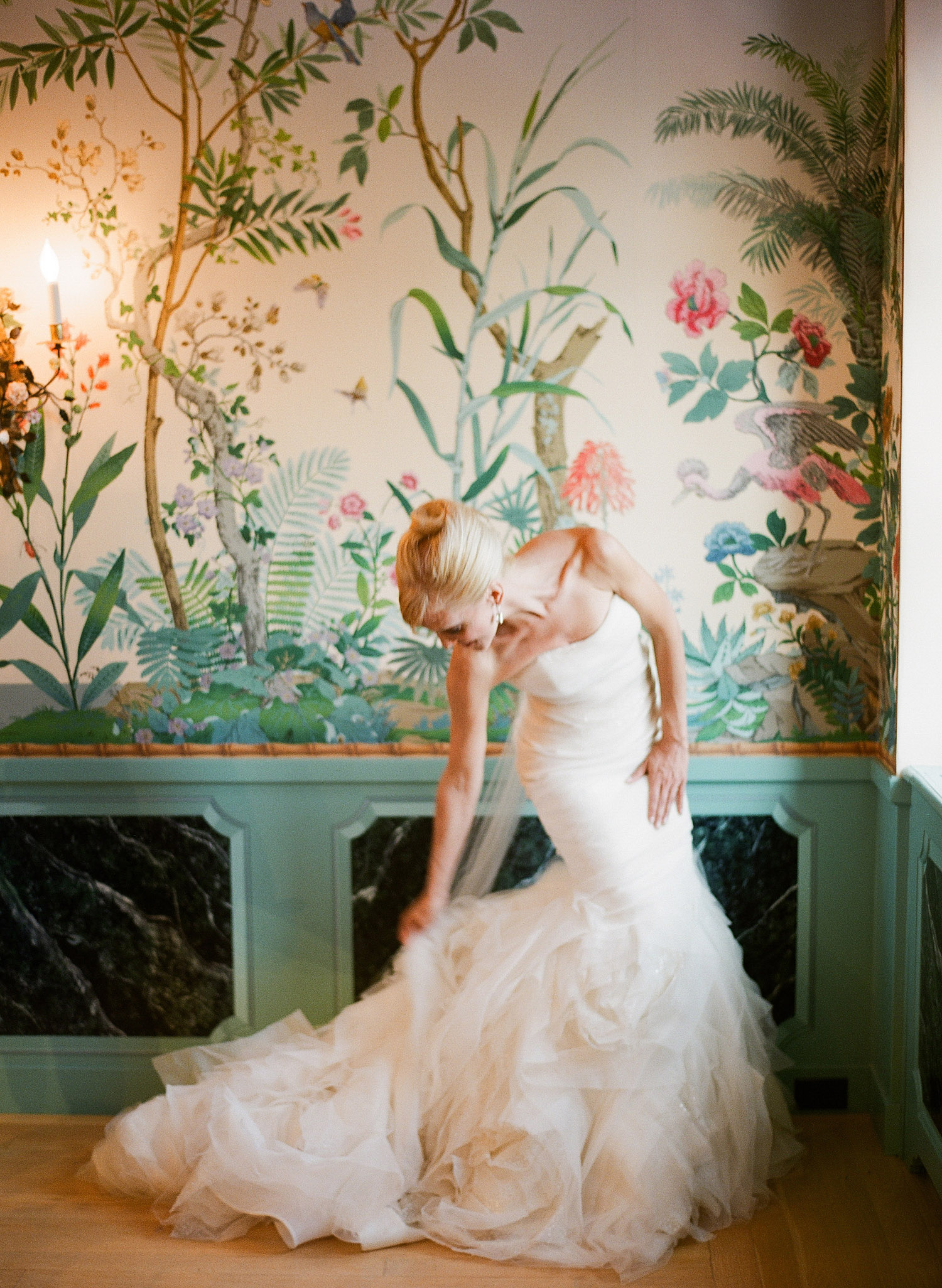 the bride adjusts her huge train in her designer wedding gown at this Italian Villa wedding at the Villa Terrace where Destination wedding photographer, Lexia Frank photographs the wedding entirely on film