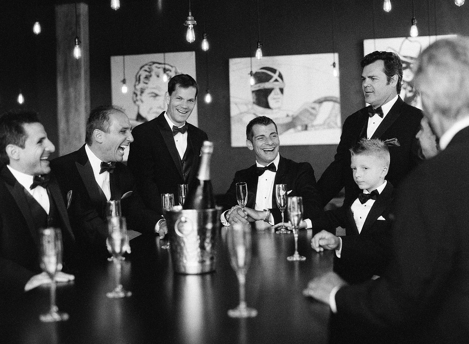 groomsmen share champagne at this italian villa wedding at the Villa Terrace where Destination wedding photographer Lexia Frank photographs this italian wedding on black and white film