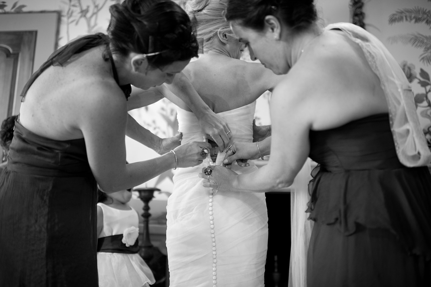 bridesmaids help the bride get dressed at this destination italian wedding at the Villa Terrace where destination wedidng photographer LExia Frank photographs this italian destination wedding entirely on film because she is a film photographer for weddings