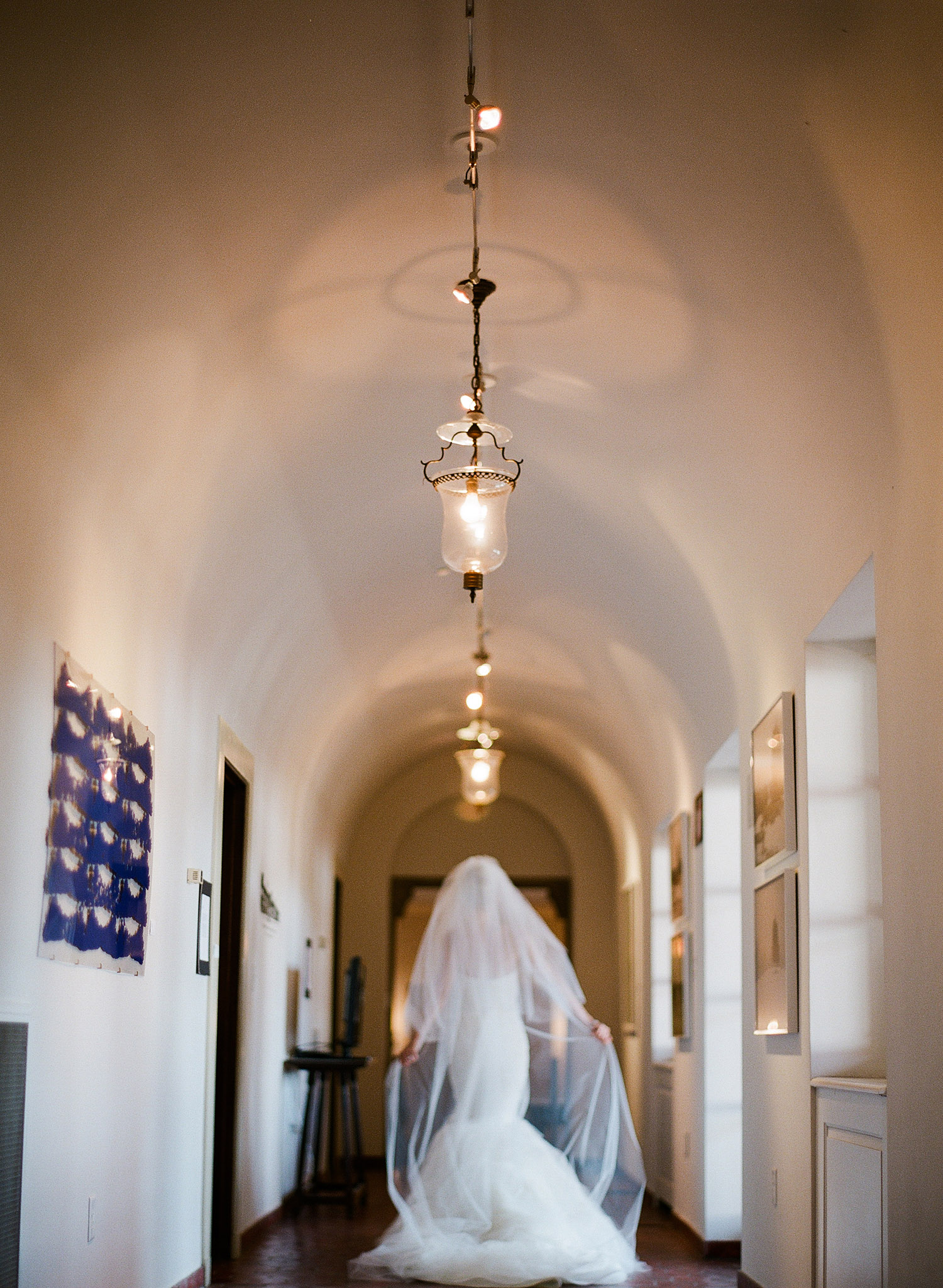 the bride walks down the hall to her Italian Destination Wedding at the Villa Terrace - a favorite wedding venue of International Destination Wedding photographer, Lexia Frank, who is a film photographer for luxury weddings worldwide.
