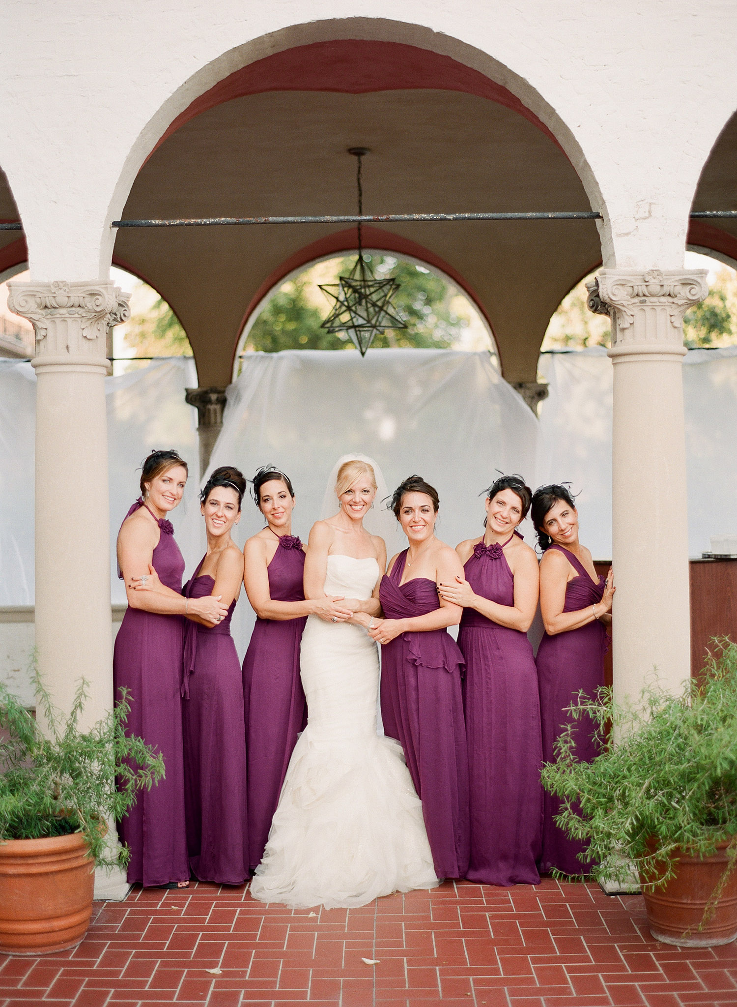 bride poses with the bridesmaids at her destination italian wedding at the Villa Terrace where Destination wedding photographer LExia Frank loves to shoot film for her luxury weddings