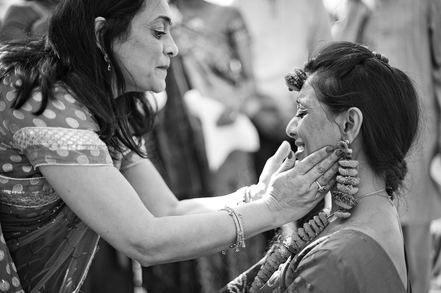 Auntie touches Indian Bride's face during this Indian Wedding in Florida captured by Destination Wedding Photographer Lexia Frank, who is a film photographer and indian wedding photographer 
