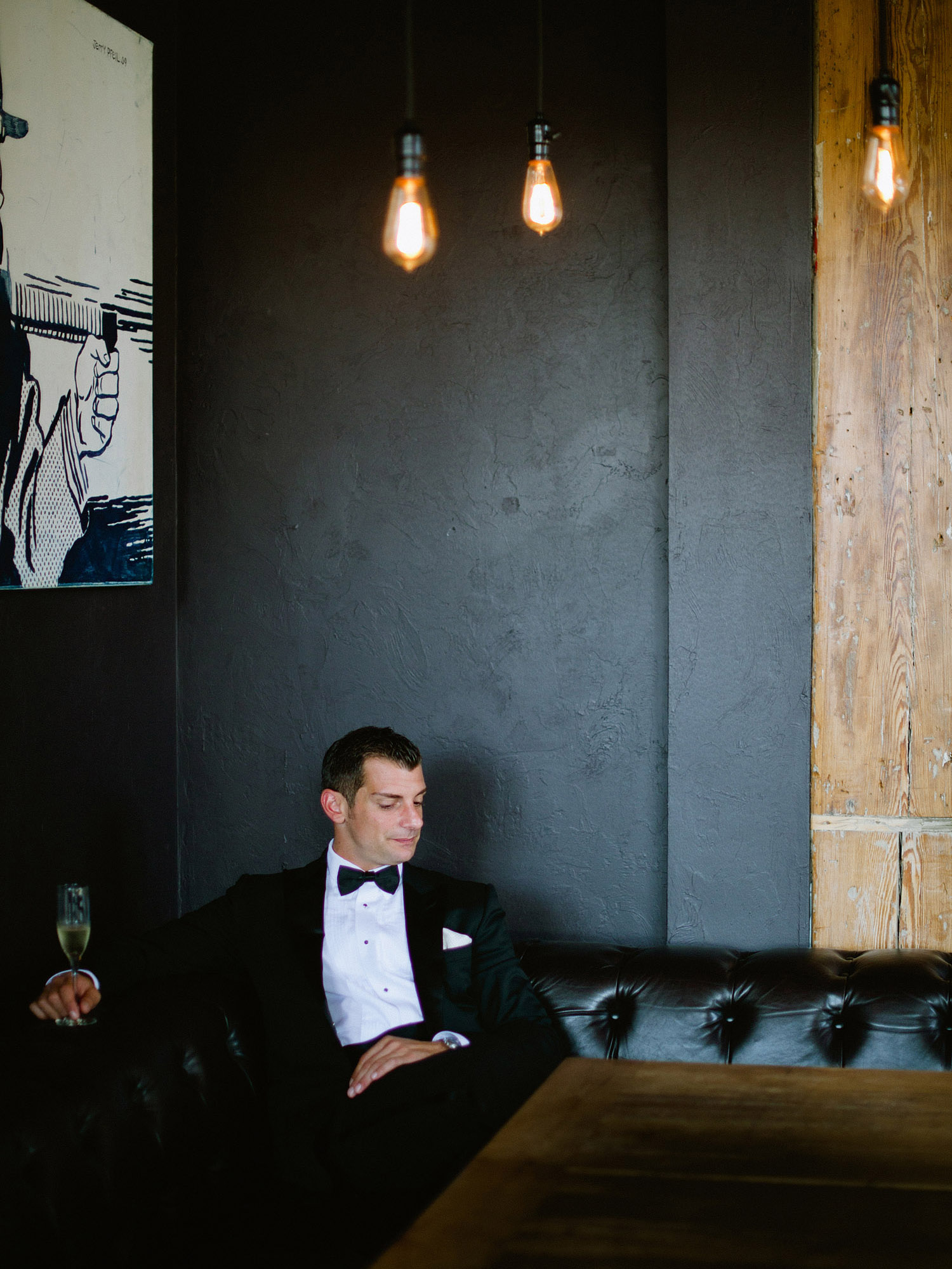 the groom sits and enjoys some champagne at this Italian Villa wedding at the Villa Terrace wedding where international destination wedding photographer Lexia Frank photographs the wedding on film because she is a film photographer for weddings internationally