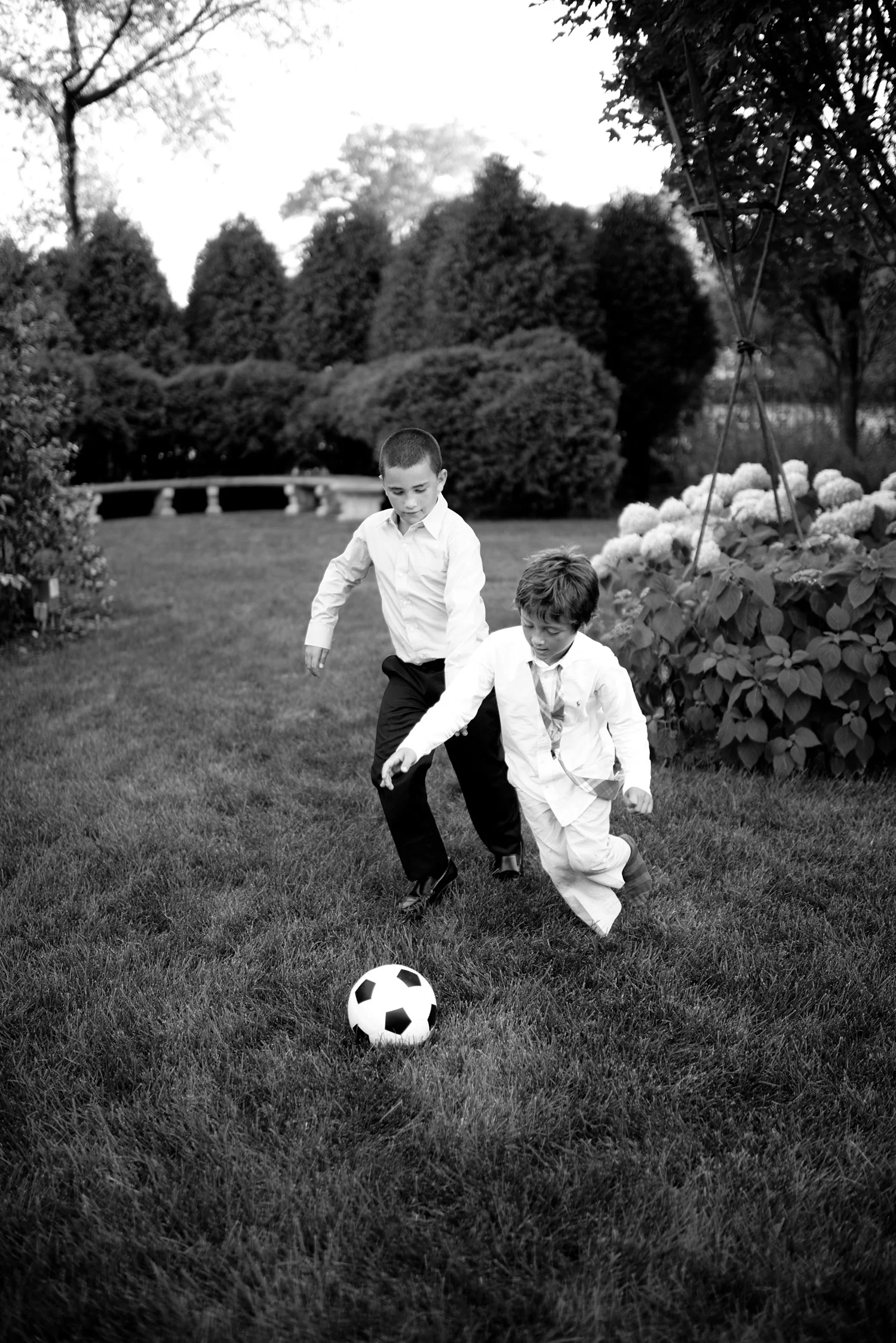 boys play soccer at the cocktail hour during this italian destination wedding at the Italian Villa, The villa Terrace, a beautiful italian wedding venue. Destination wedding photographer Lexia Frank photographs this wedding on film 