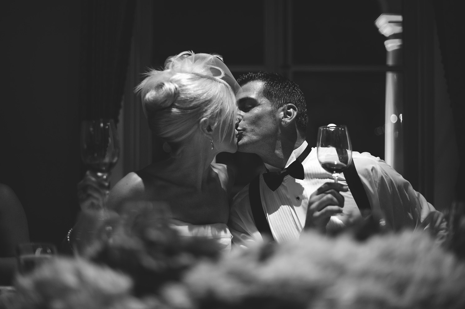 the bride and groom cheers during speeches at the reception of their italian wedding at the italian villa wedding venue, The villa Terrace, while Destination Wedding photographer Lexia Frank photographs the wedding on film 