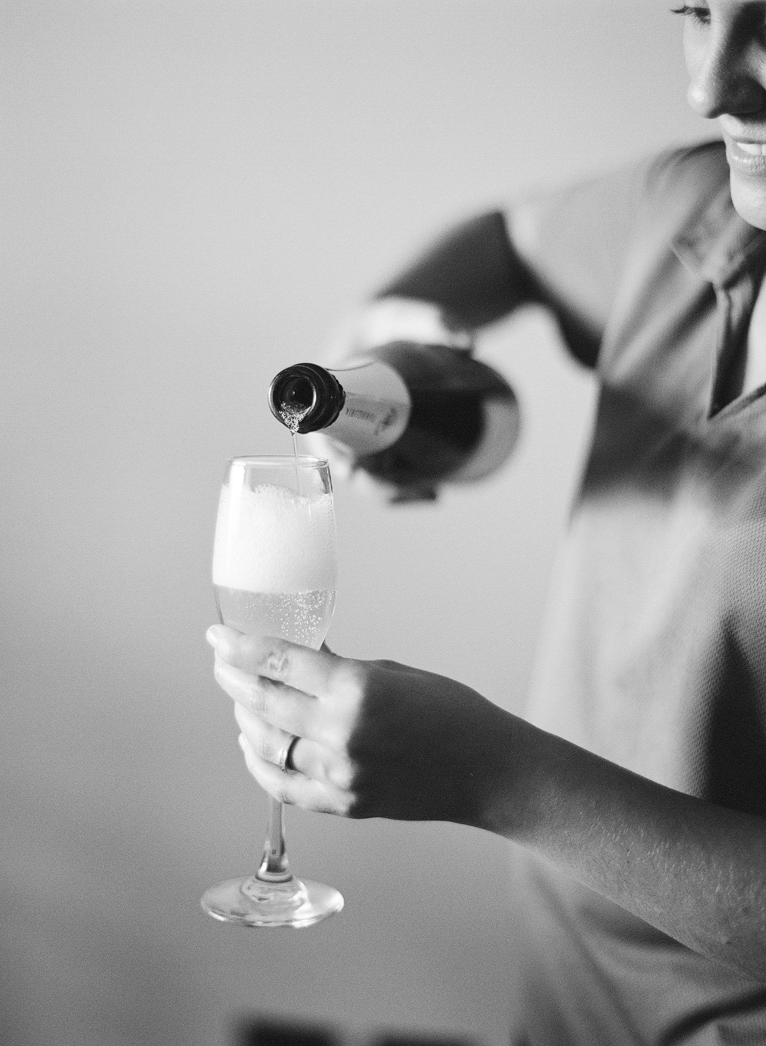 champagne is poured at this destination wedding at the W hotel in Vieques Island Puerto Rico while Destination wedding photographer Lexia Frank photographs this vieques Wedding Photographer on film 